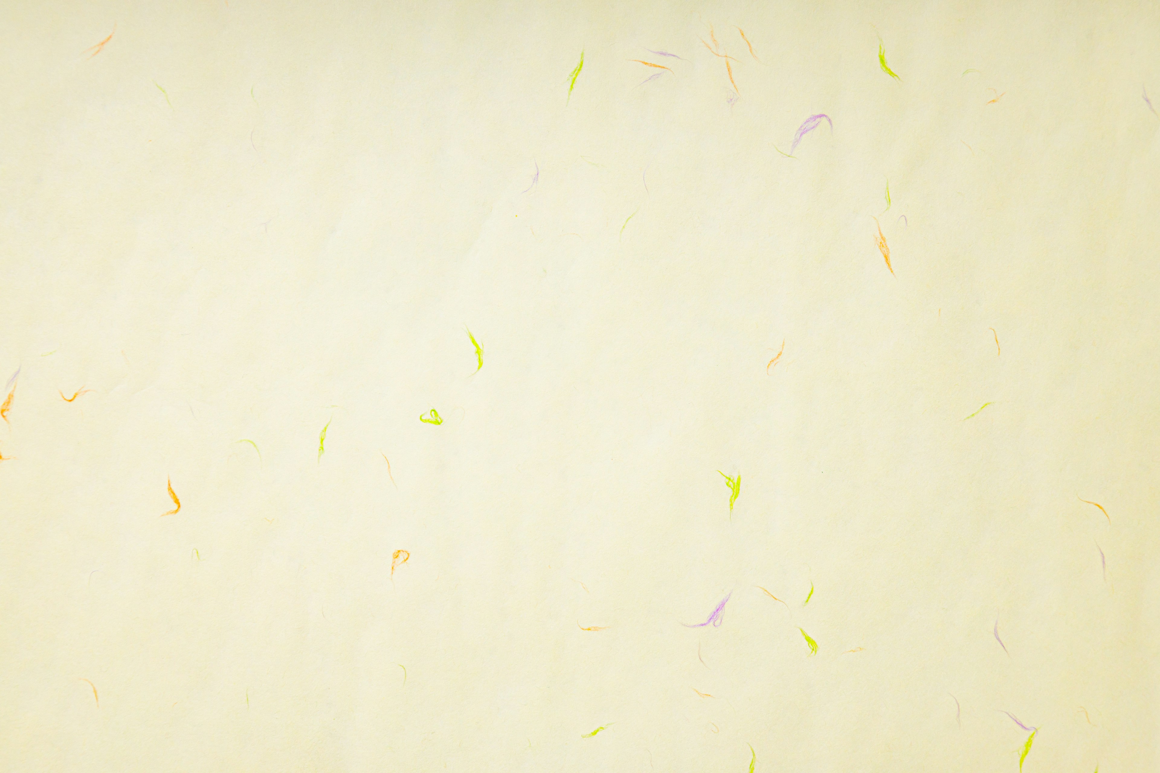 Light cream-colored background with scattered colorful speckles