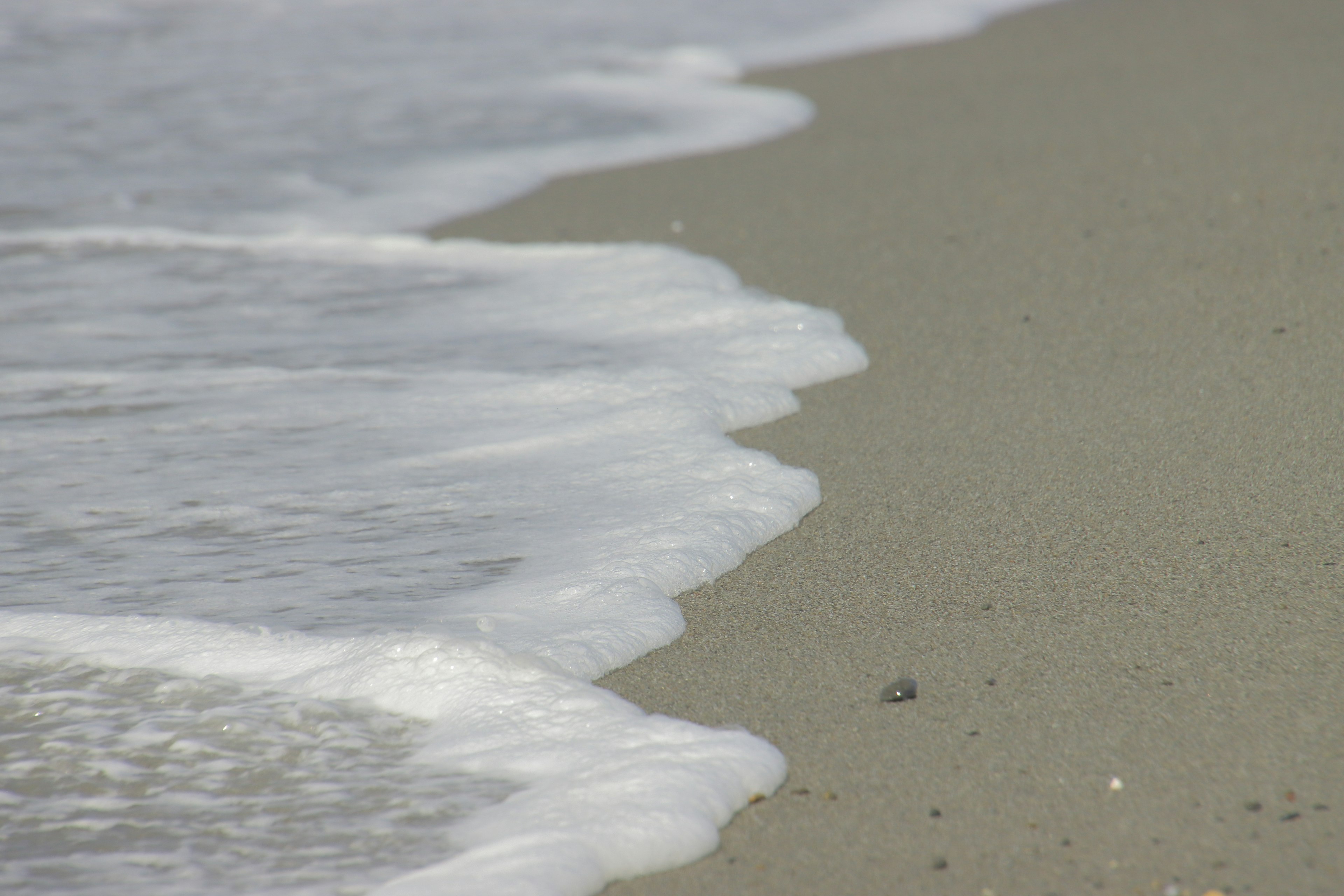 Waves gently lapping on a sandy beach