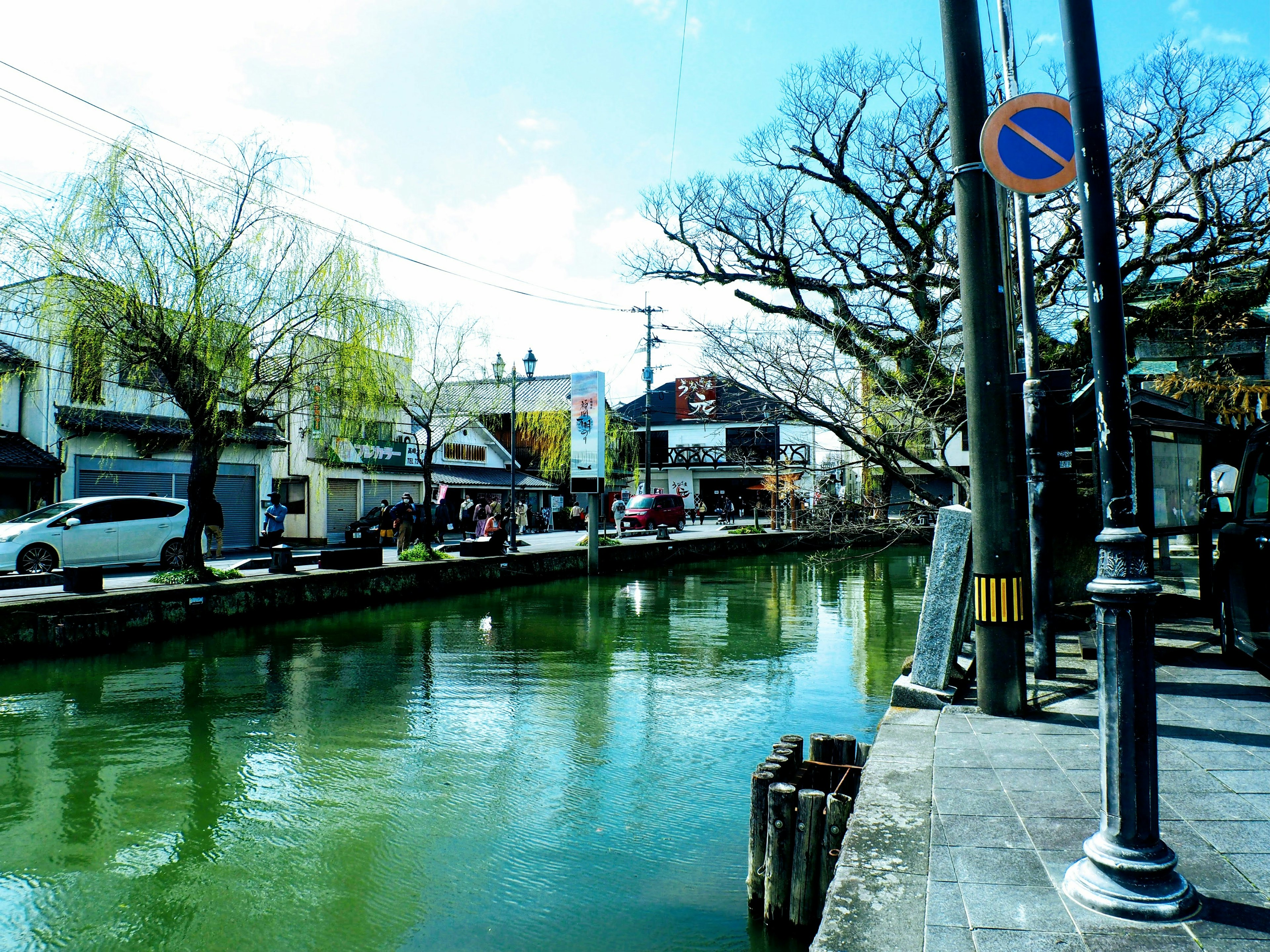 Scenic view of a quiet canal with trees and buildings