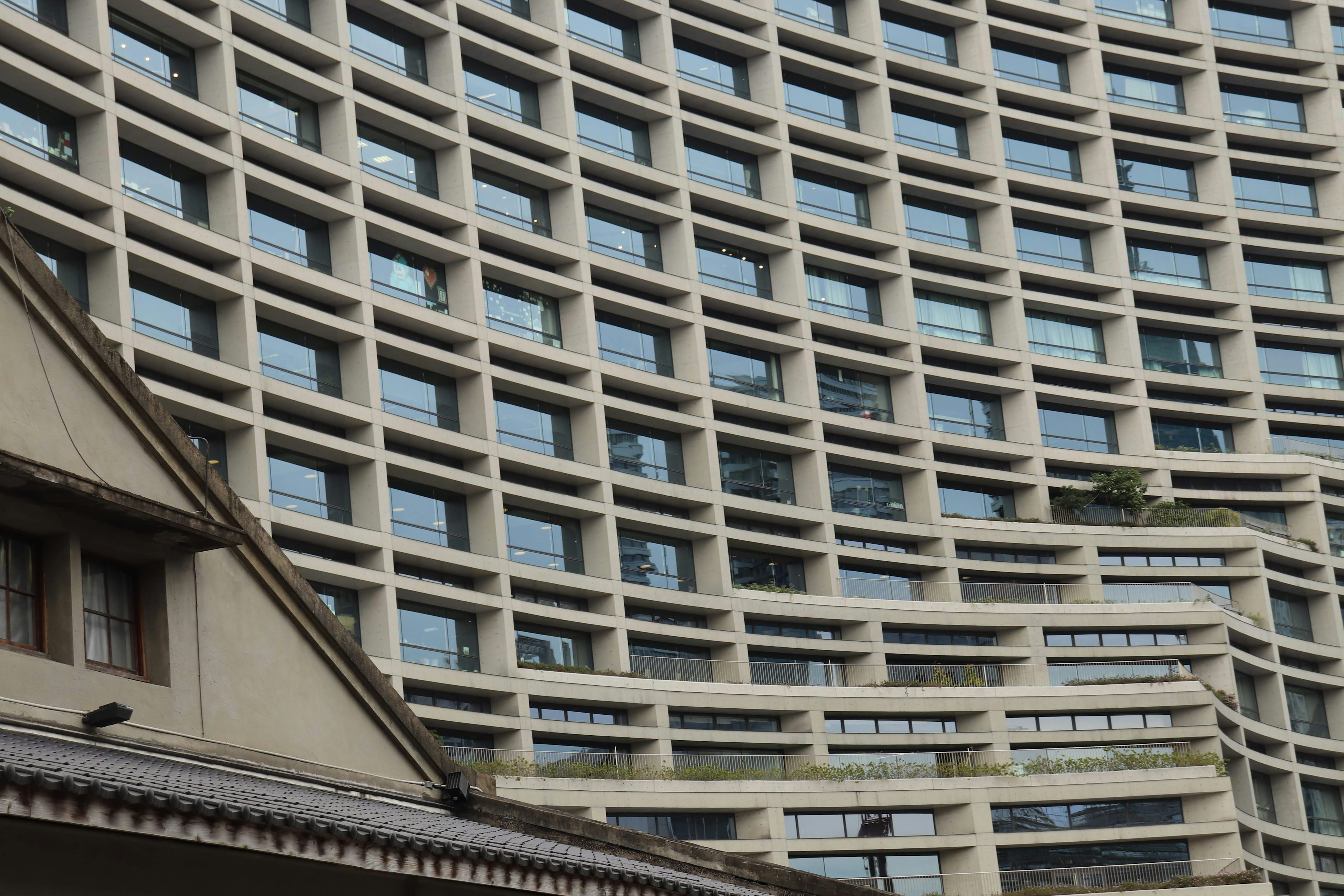 Curved facade of a modern building with a unique window pattern