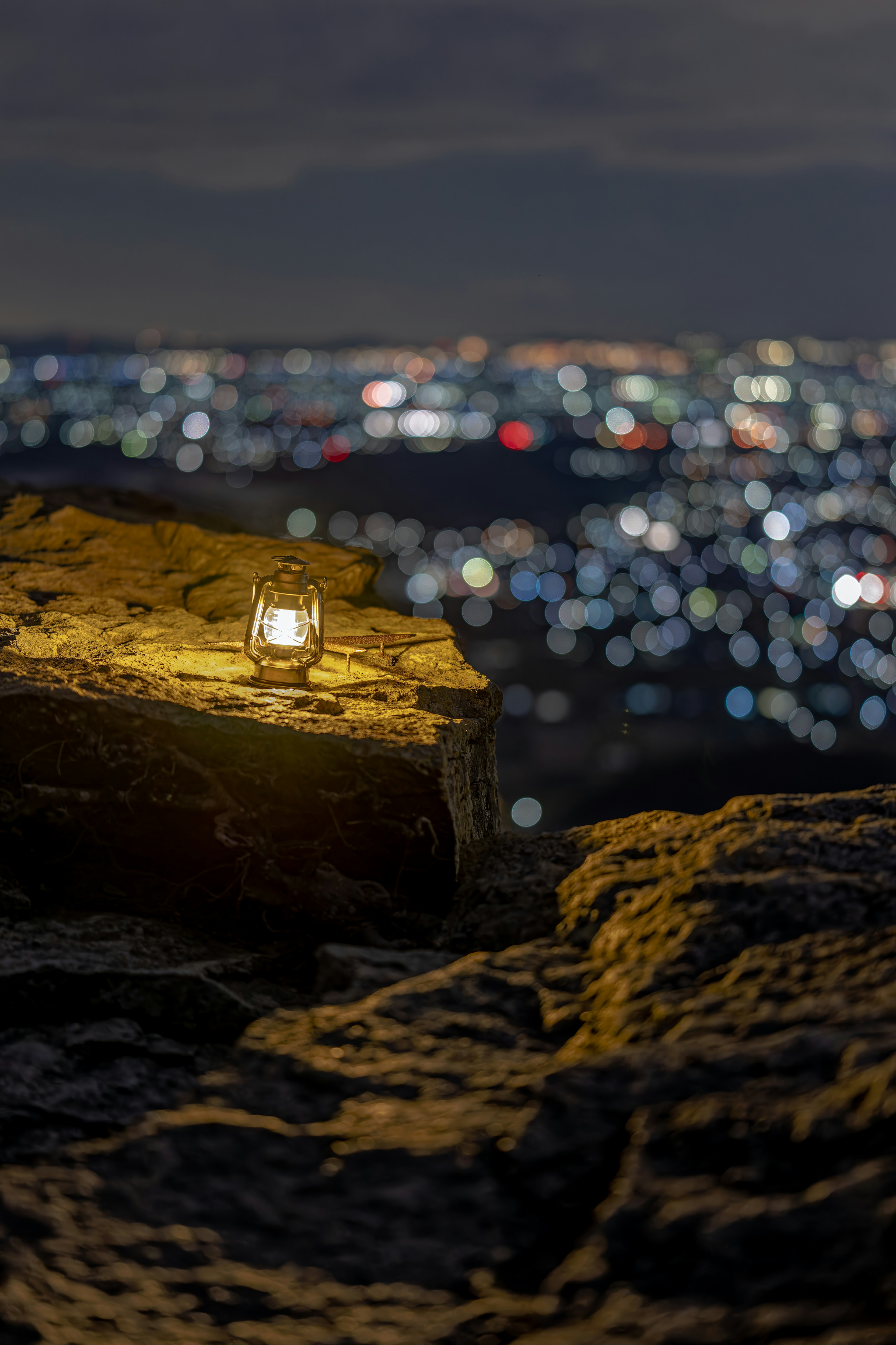 夜景をバックにした岩の上のキャンドル