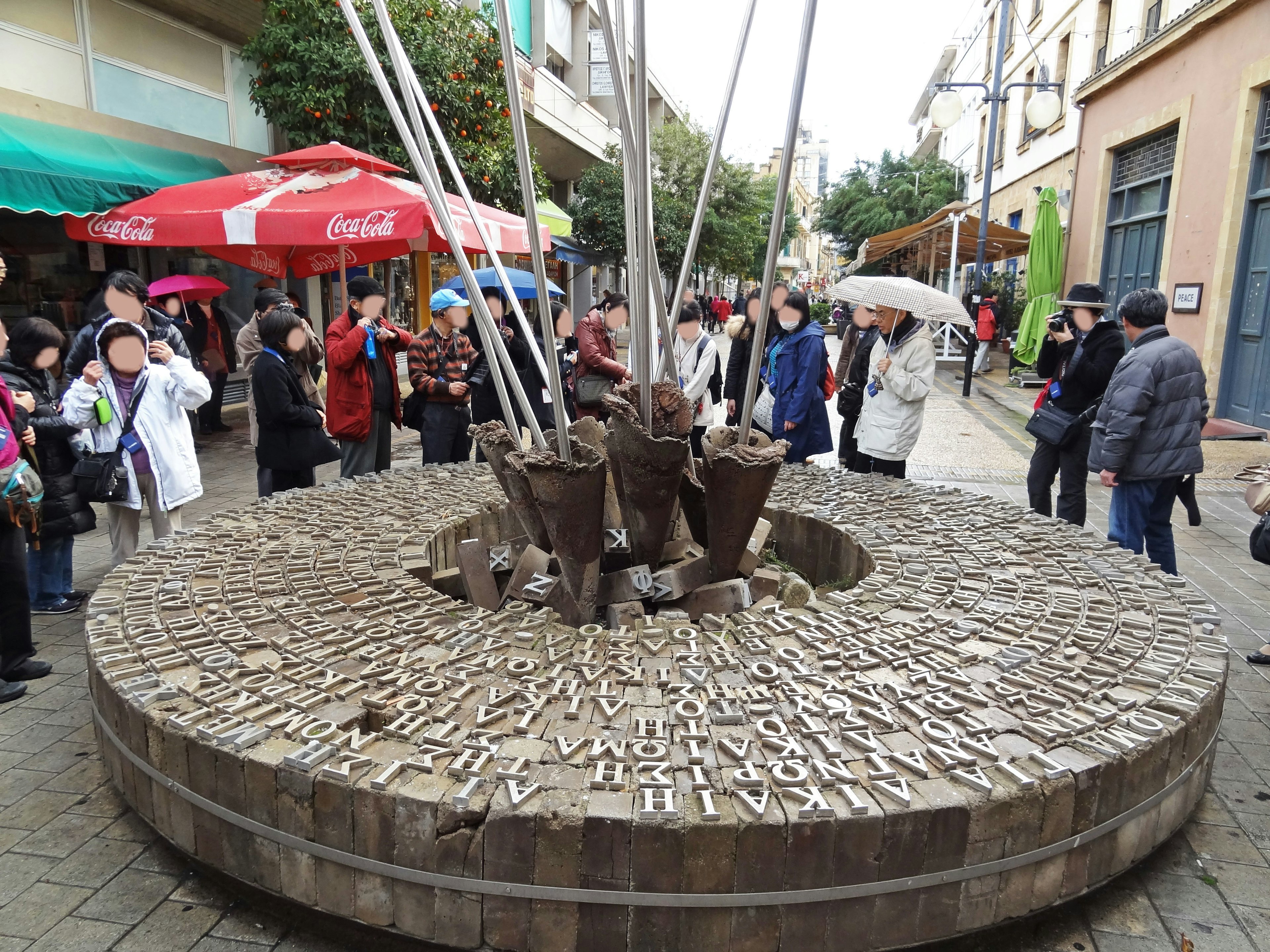 Crowd gathered around a unique sculpture in a lively street setting