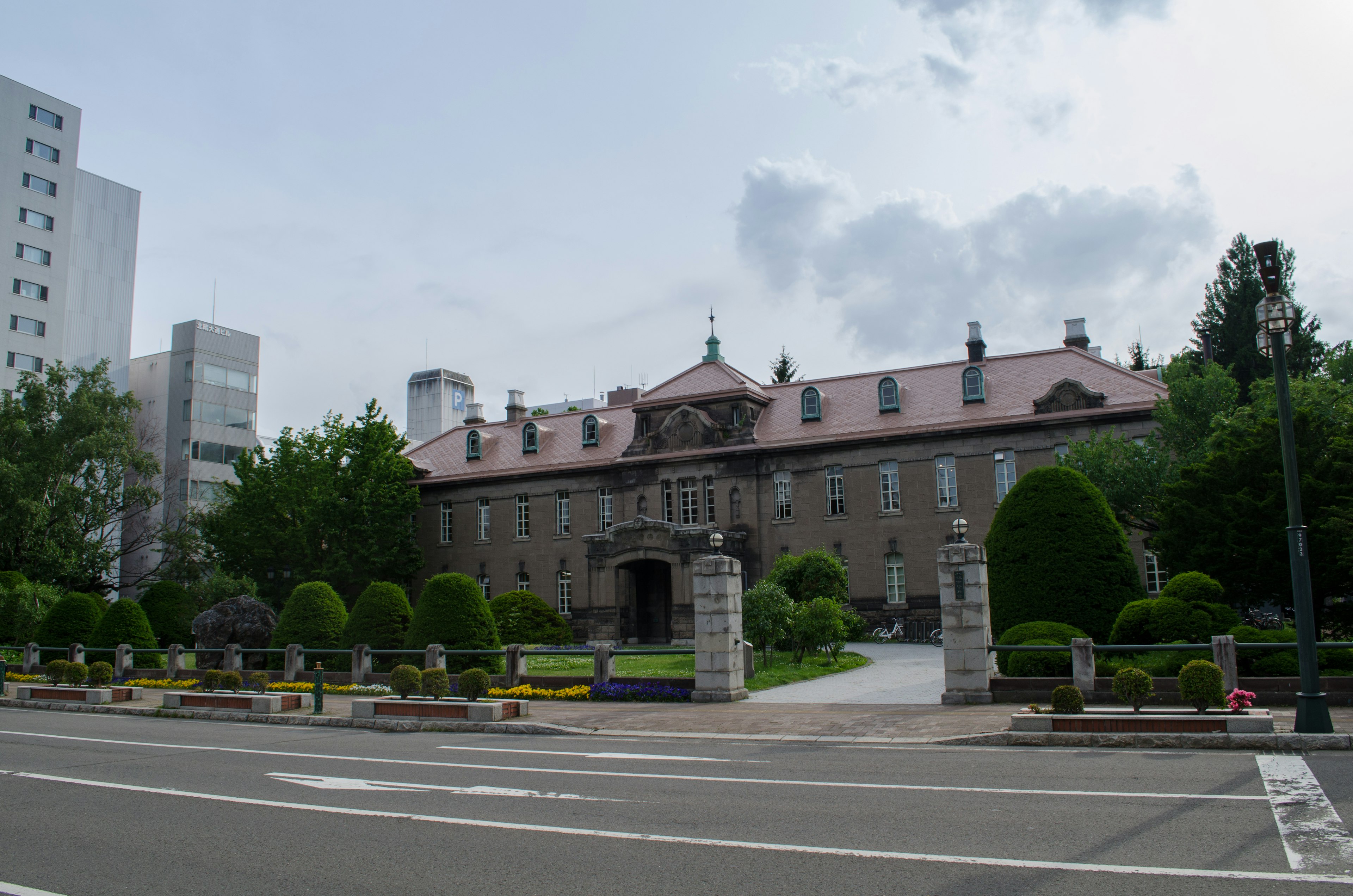 Historic building with well-maintained gardens surrounding it