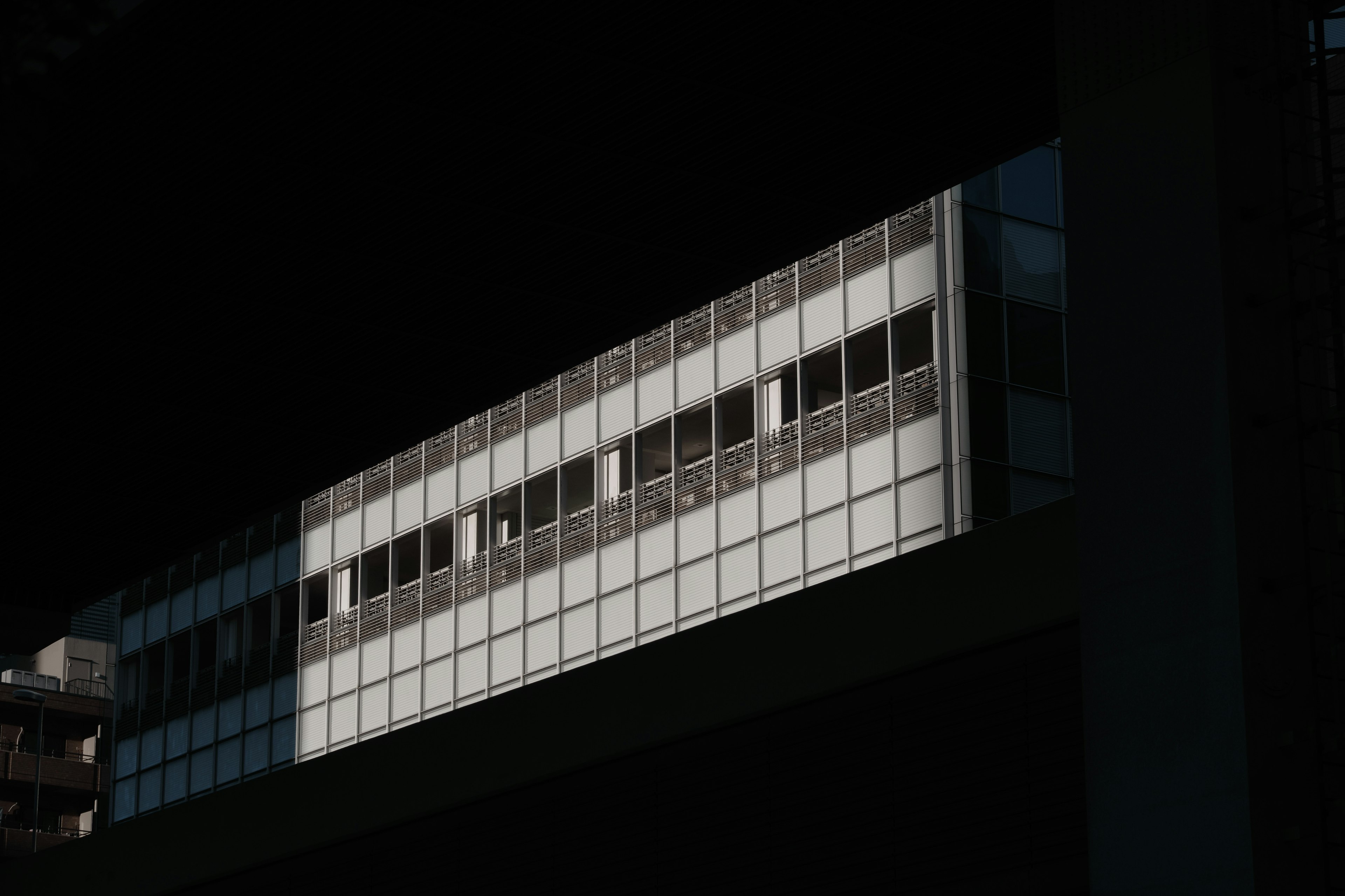 Facade of a modern building partially illuminated with detailed windows