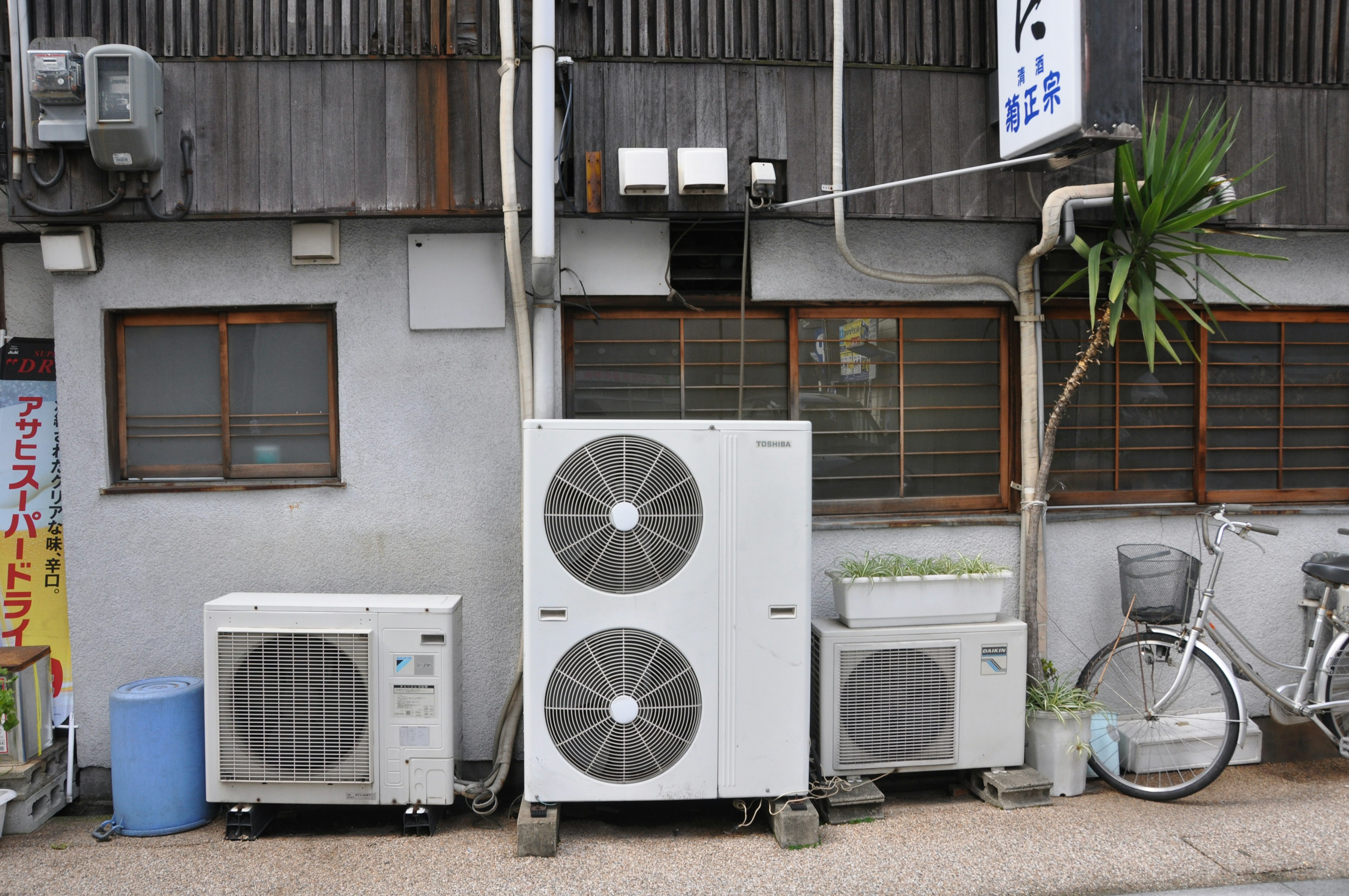 Outdoor air conditioning units and a bicycle in a city scene