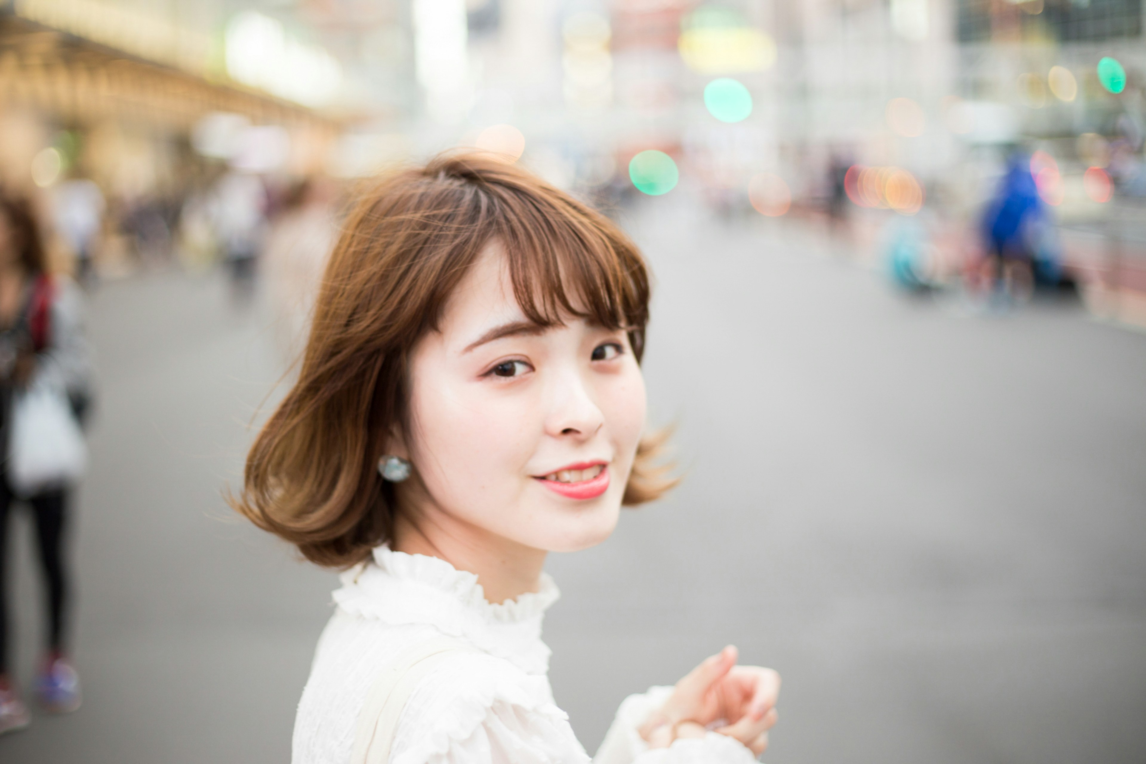 A smiling woman walking in a busy street