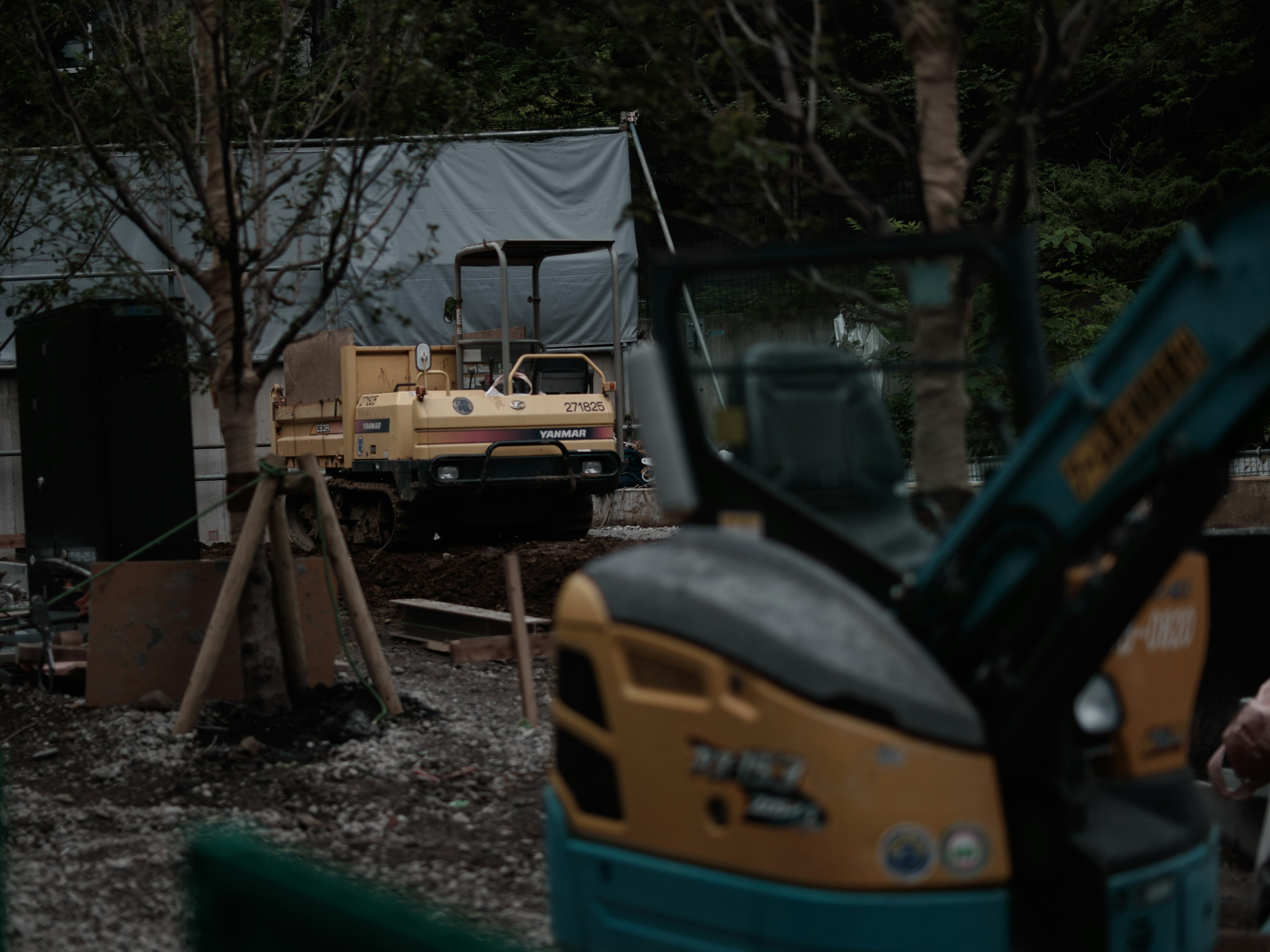 Construction site featuring heavy machinery and a building in the background