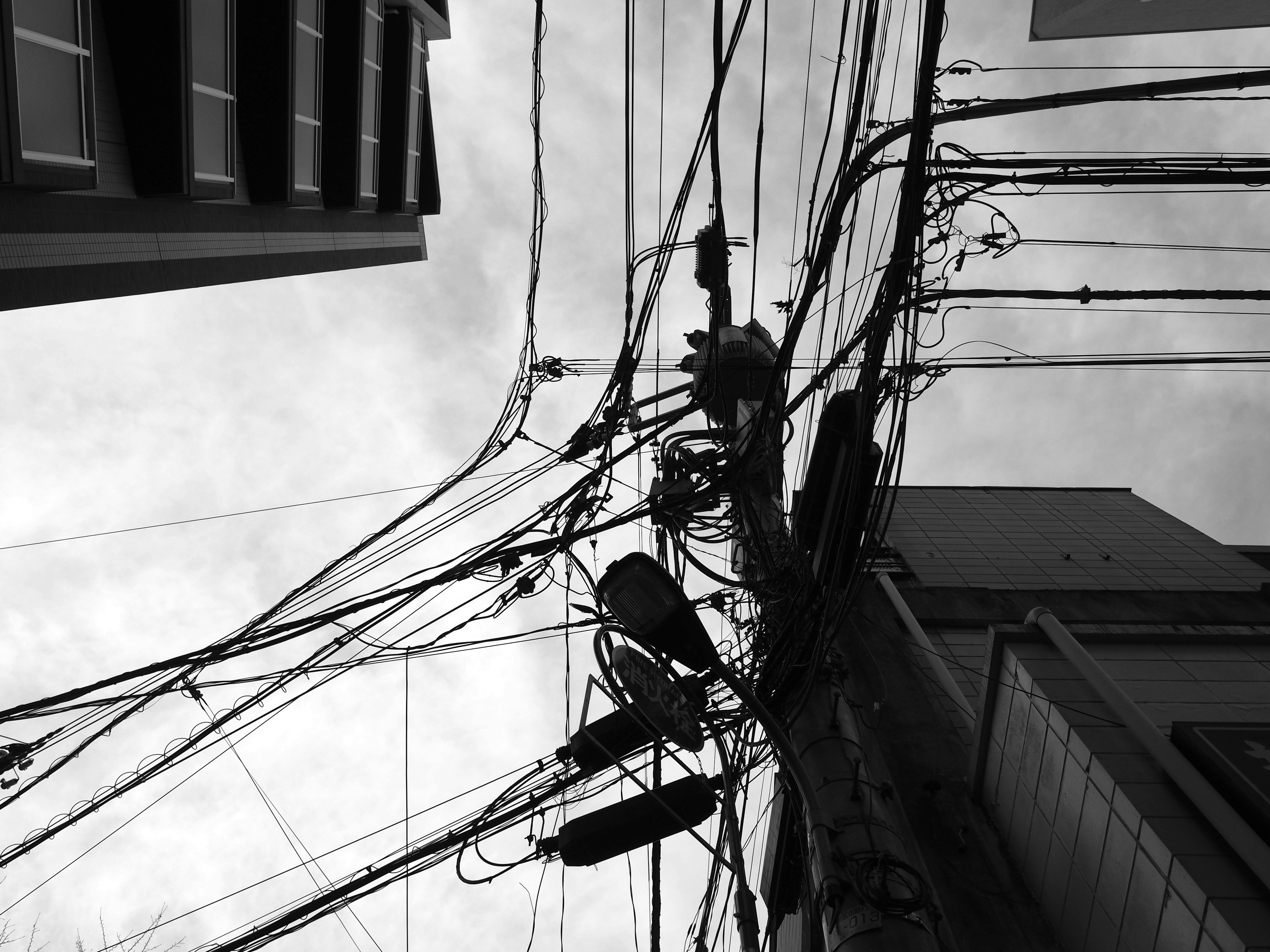 Urban landscape with intersecting power lines and buildings