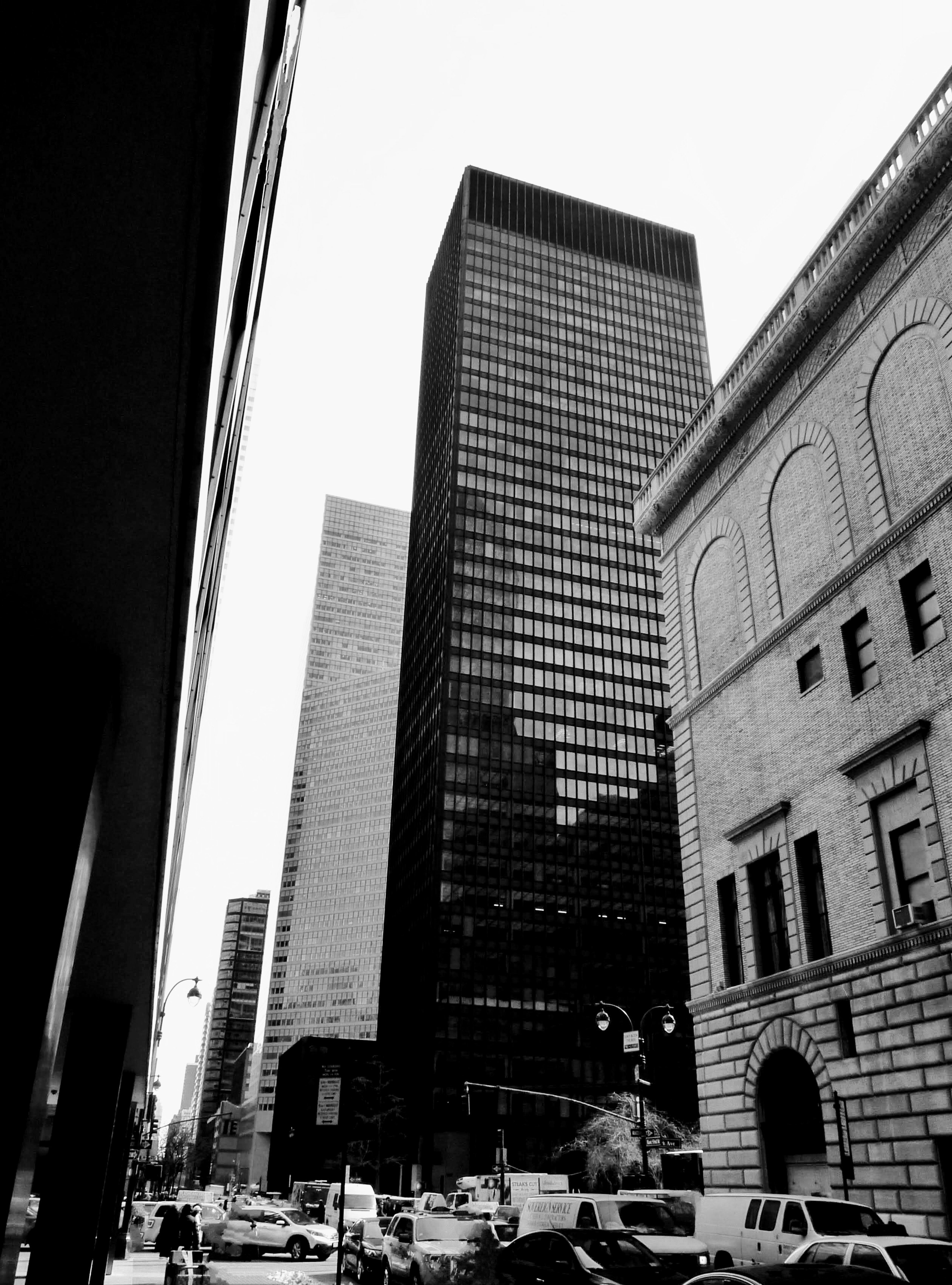 Black and white cityscape featuring tall buildings and busy streets