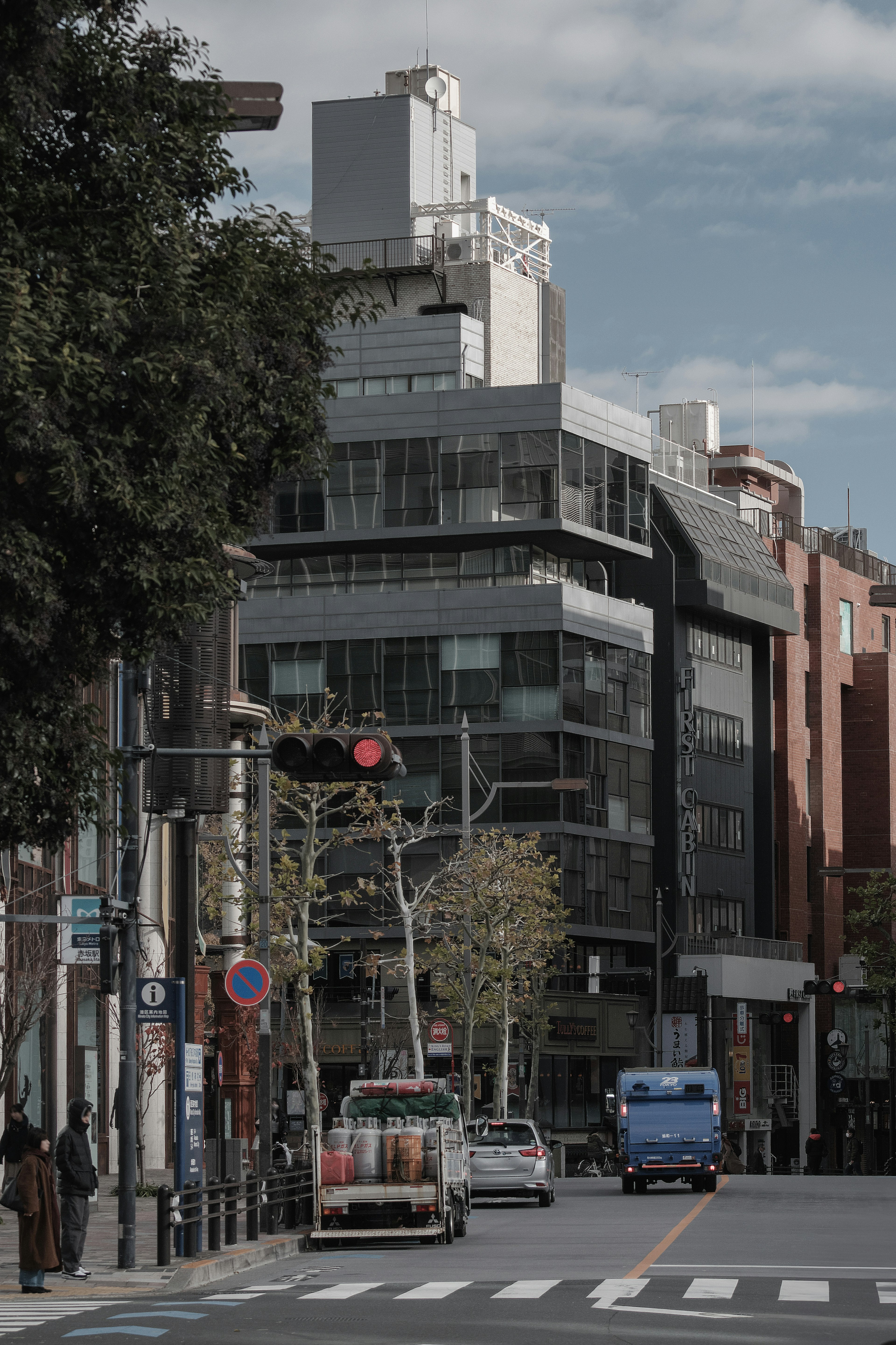 Urban street scene with modern buildings and a red traffic light