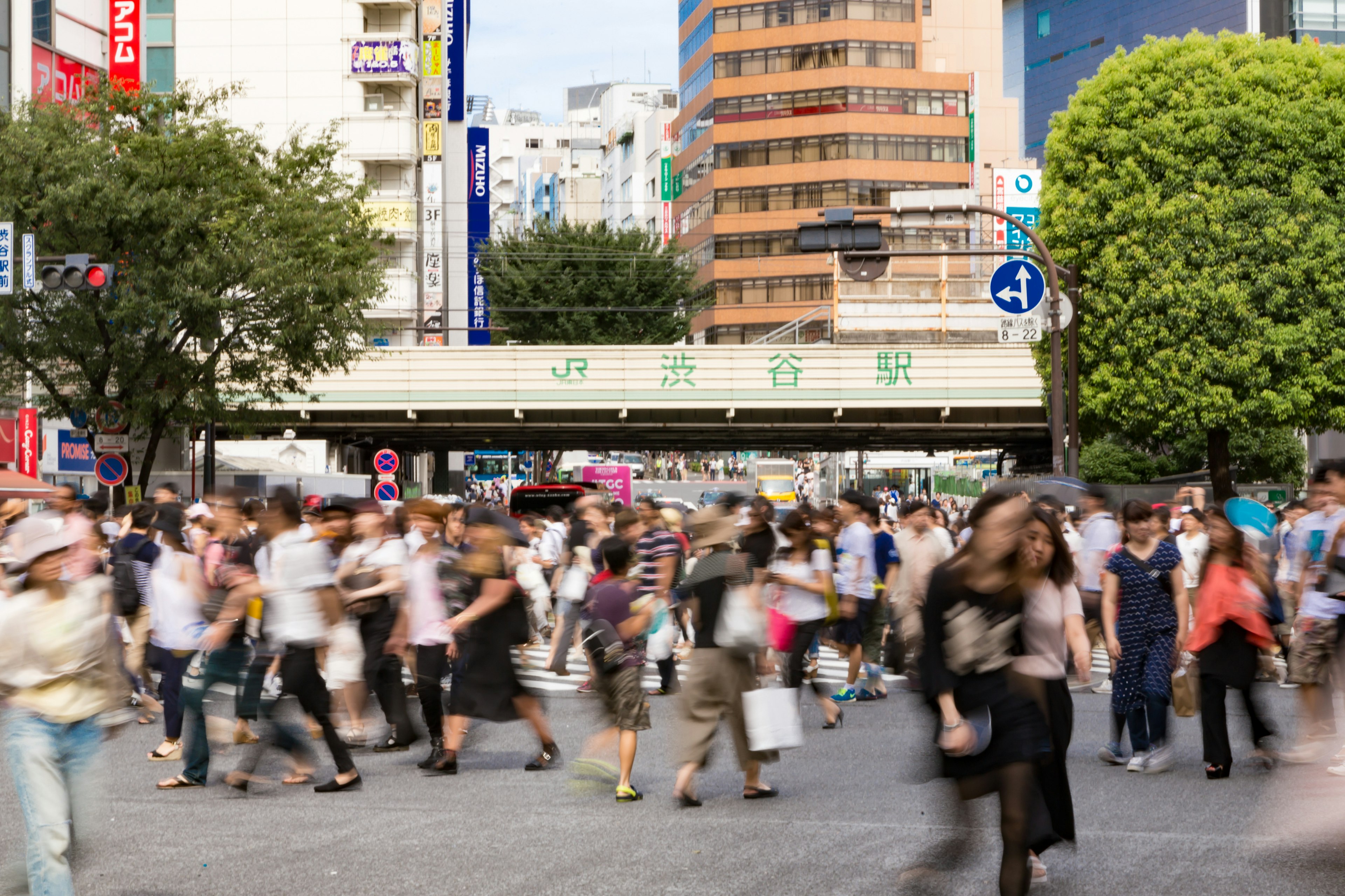 Busy intersection with people walking and high-rise buildings