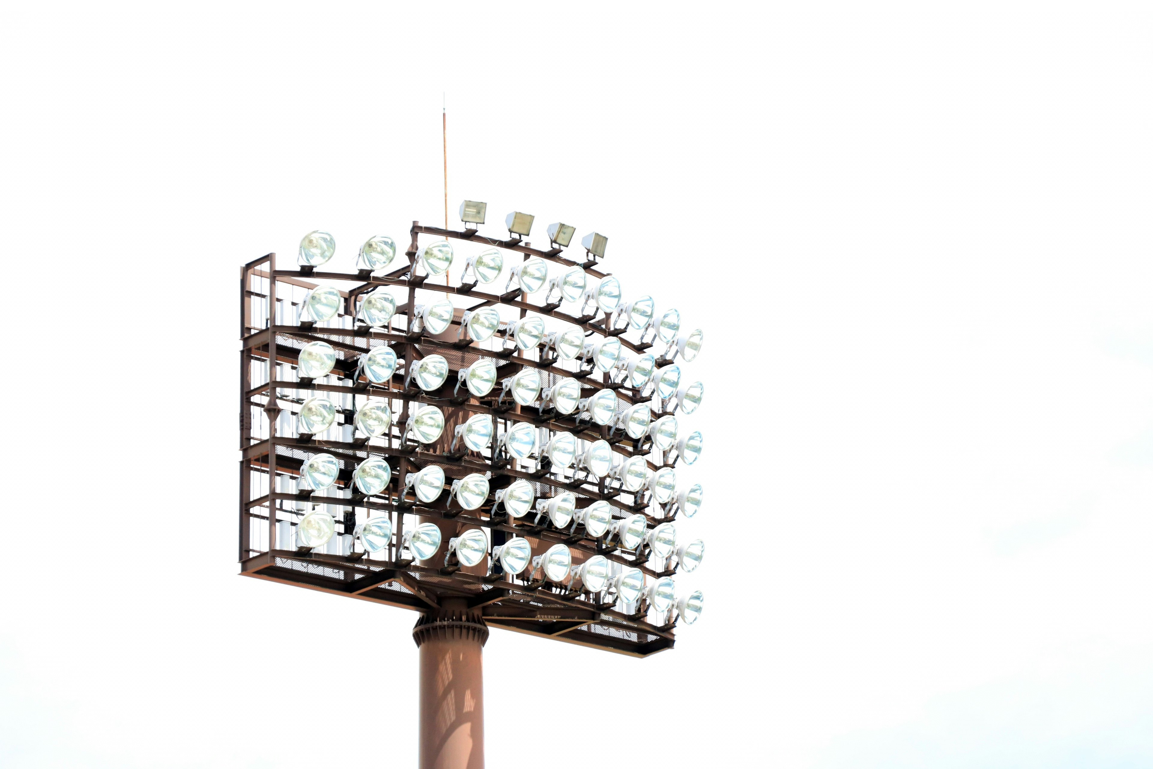 Tall lighting tower for sports facility with multiple bright lights