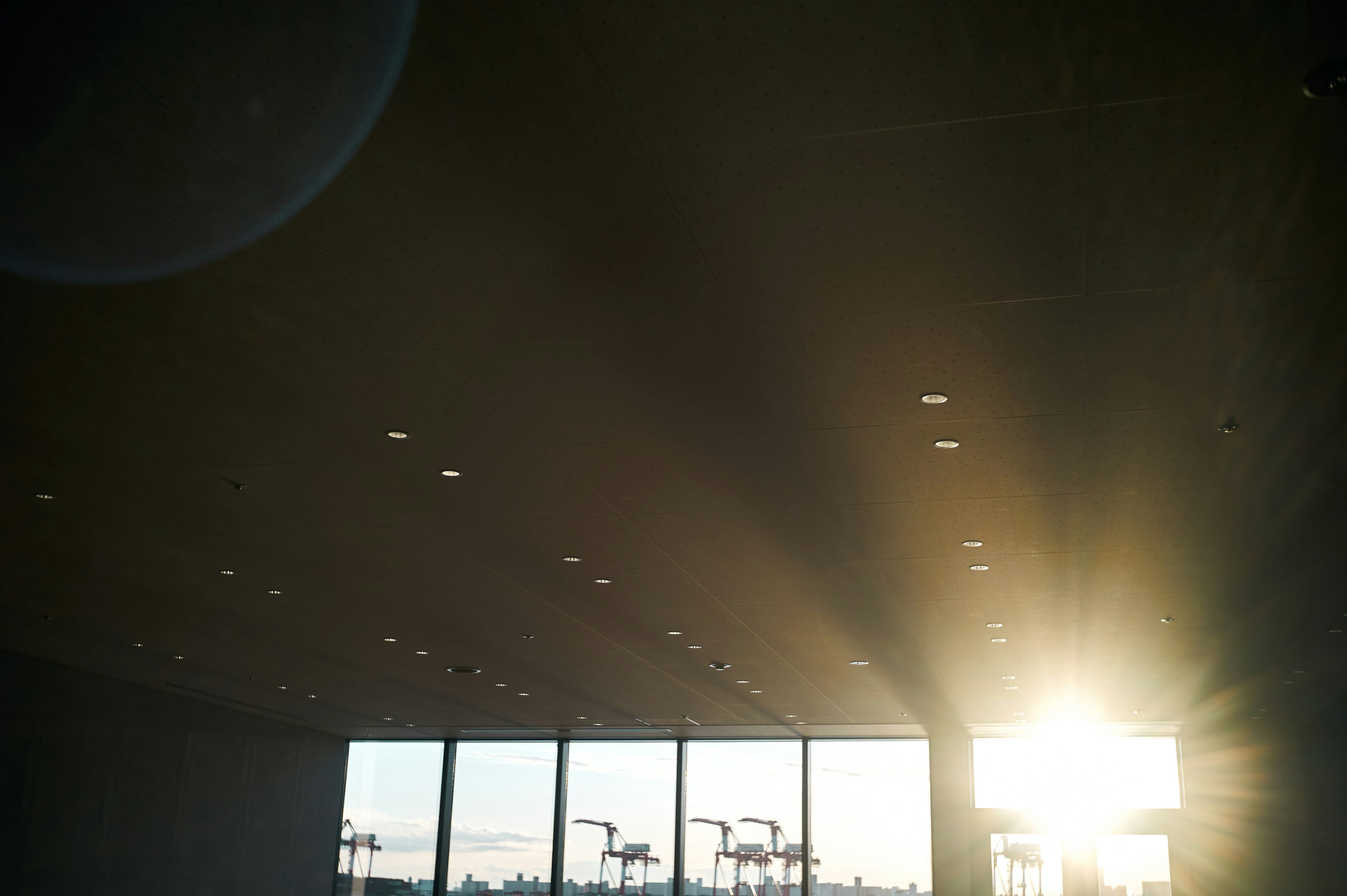 Interior view with sunlight streaming through large windows and ceiling lights