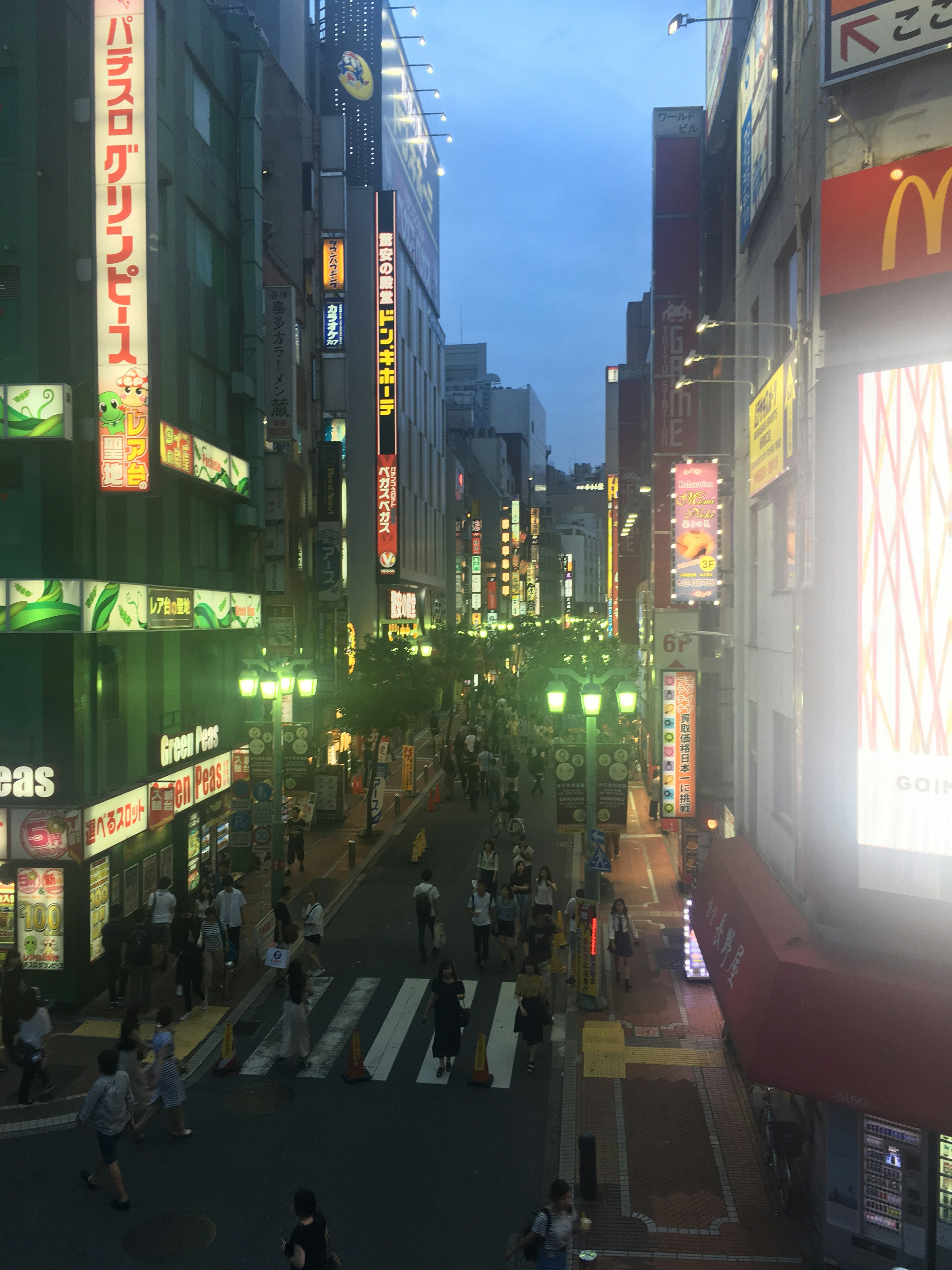 Bustling city street with bright neon signs glowing in the night