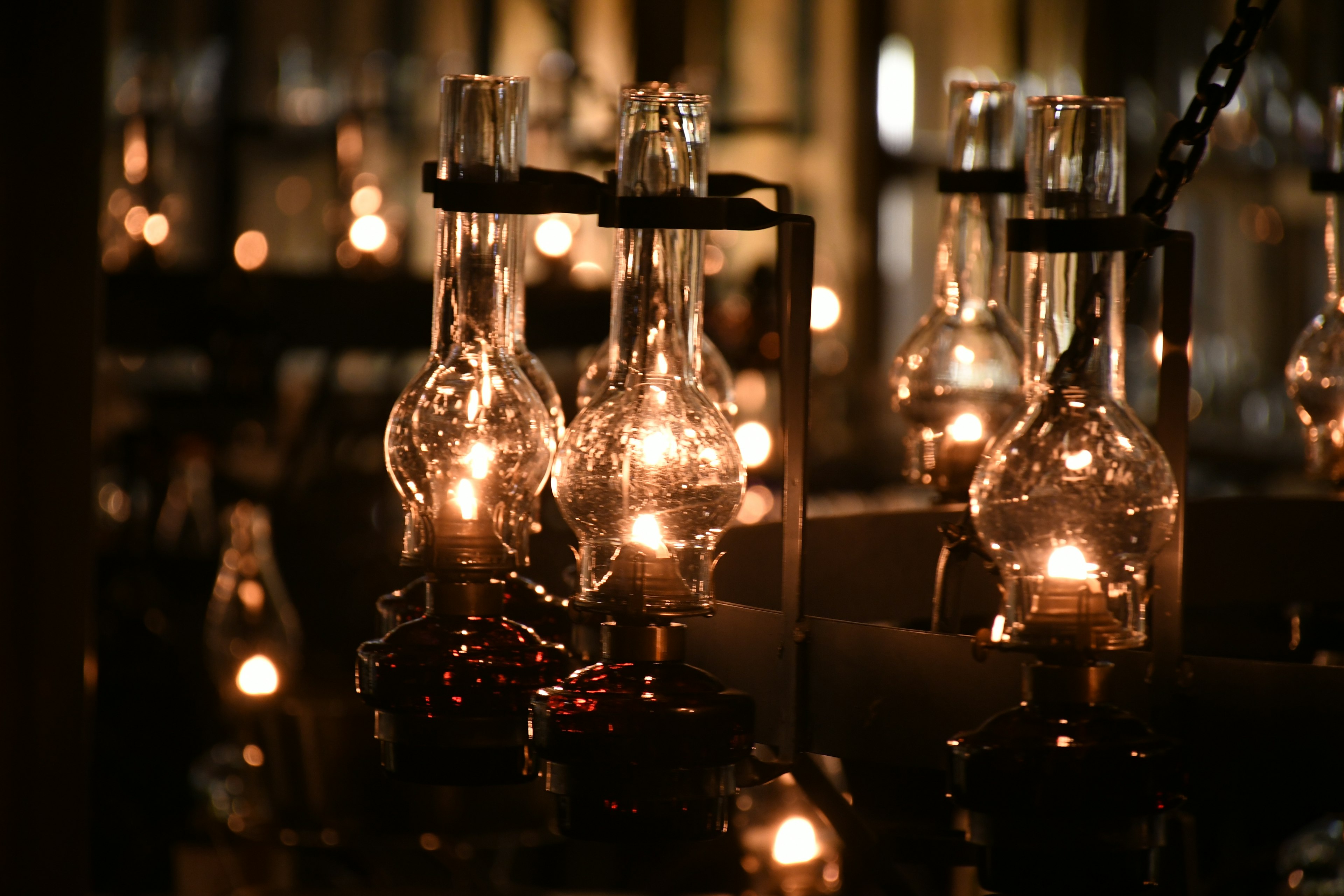 Collection of glass lamps glowing in a dark background