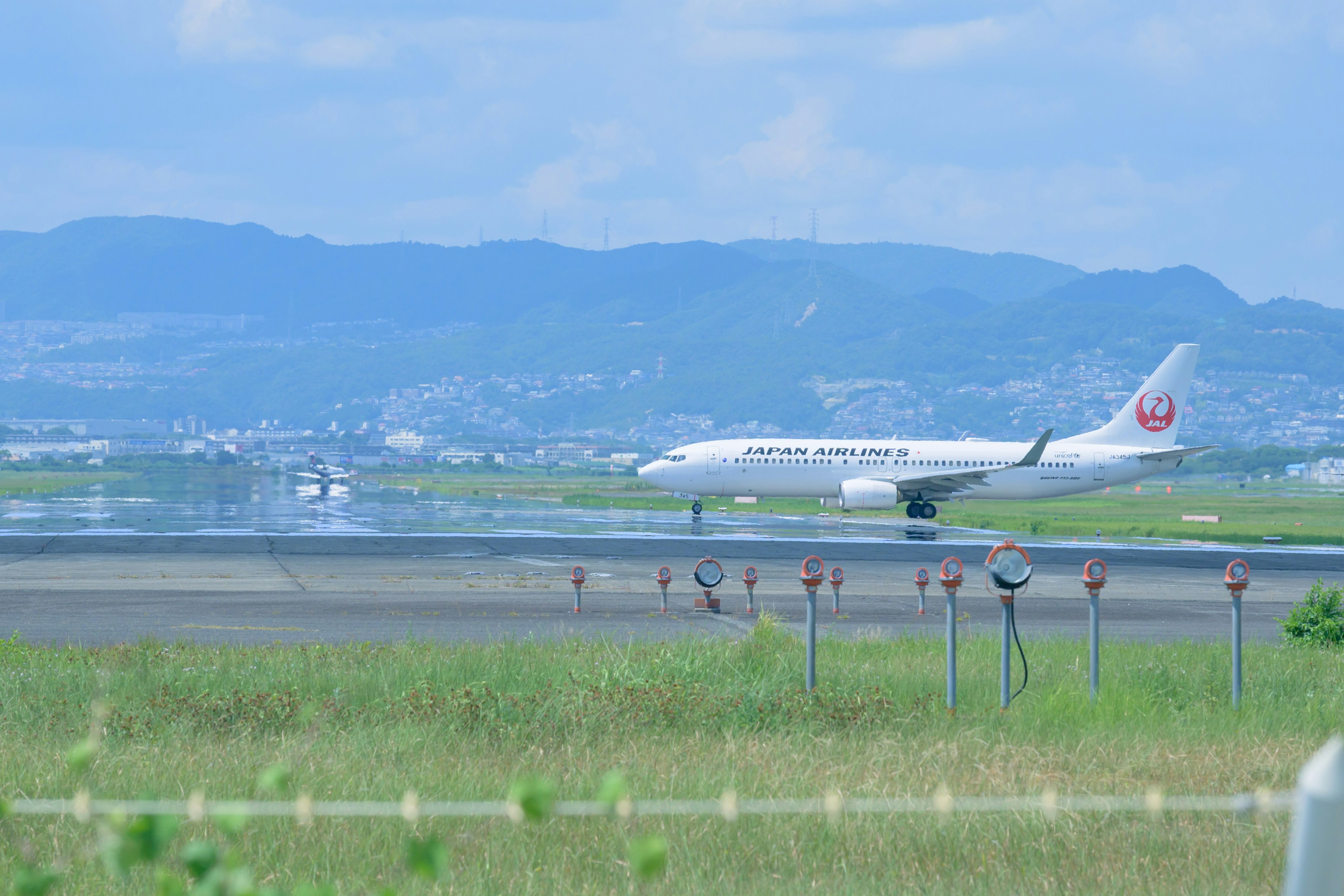 Japan Airlines aircraft taxiing on the runway at an airport