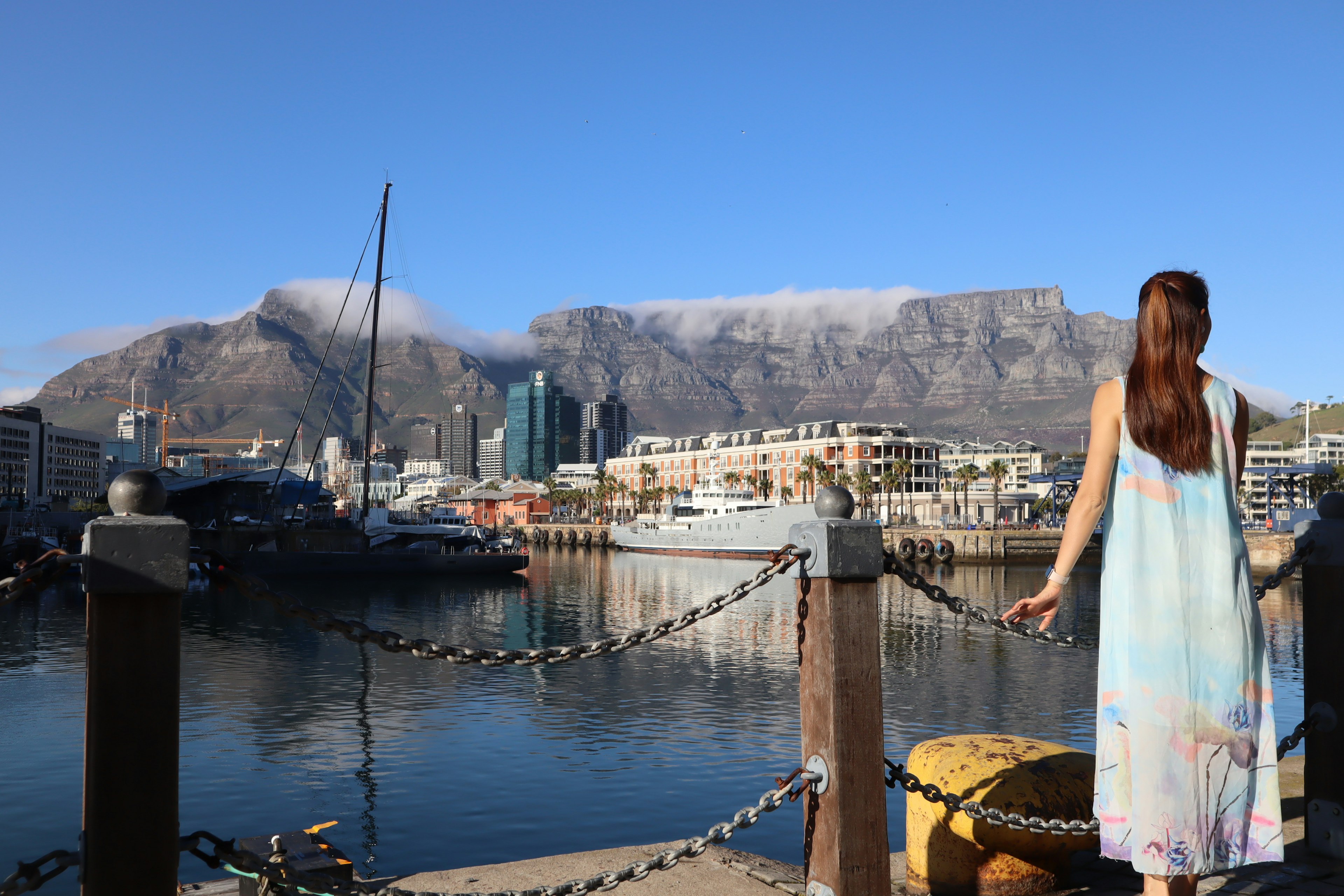 Scenic view of Table Mountain with a woman at the waterfront