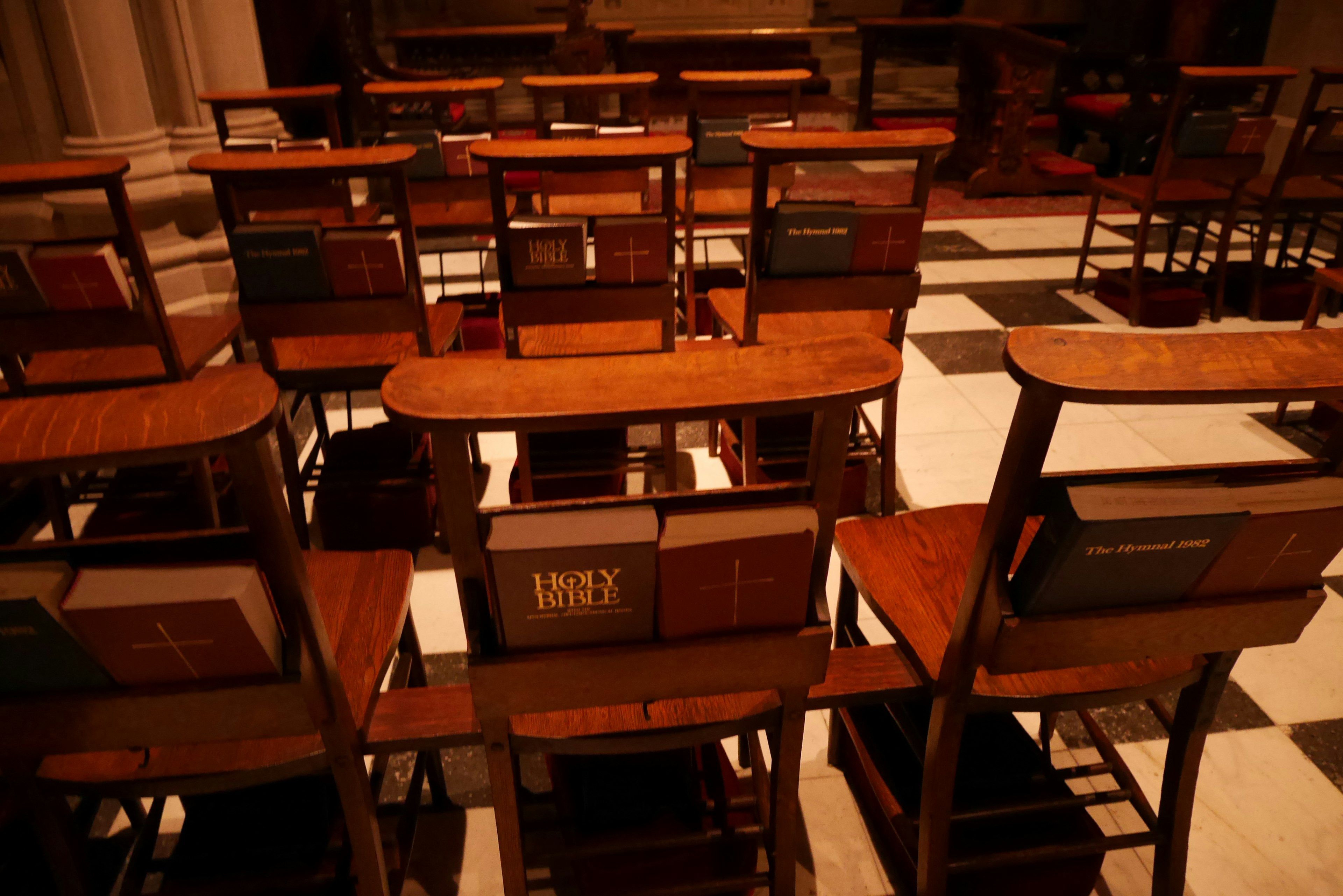 Image of wooden chairs arranged neatly inside a church