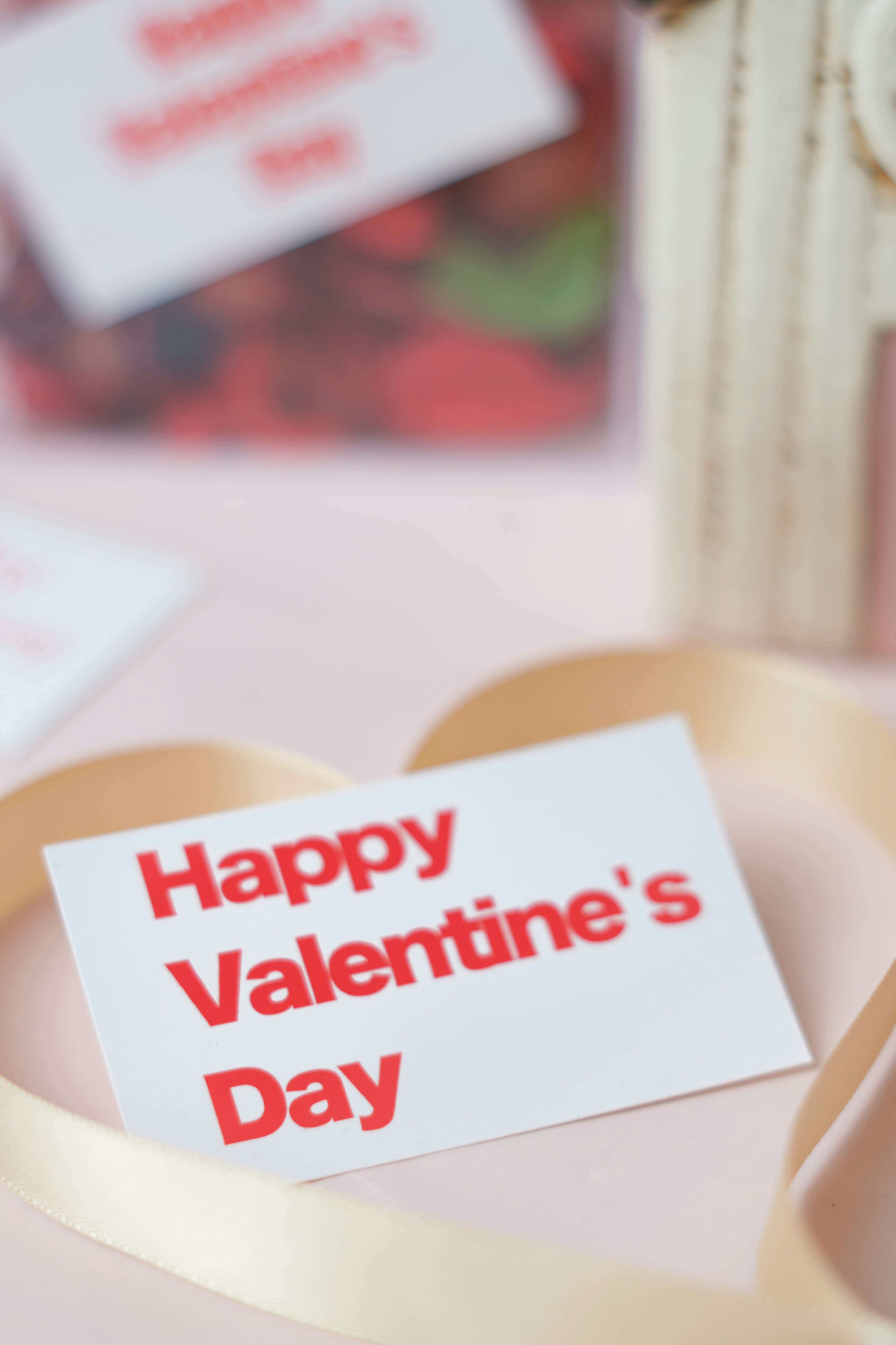 Greeting card with Happy Valentine's Day message and heart-shaped ribbon