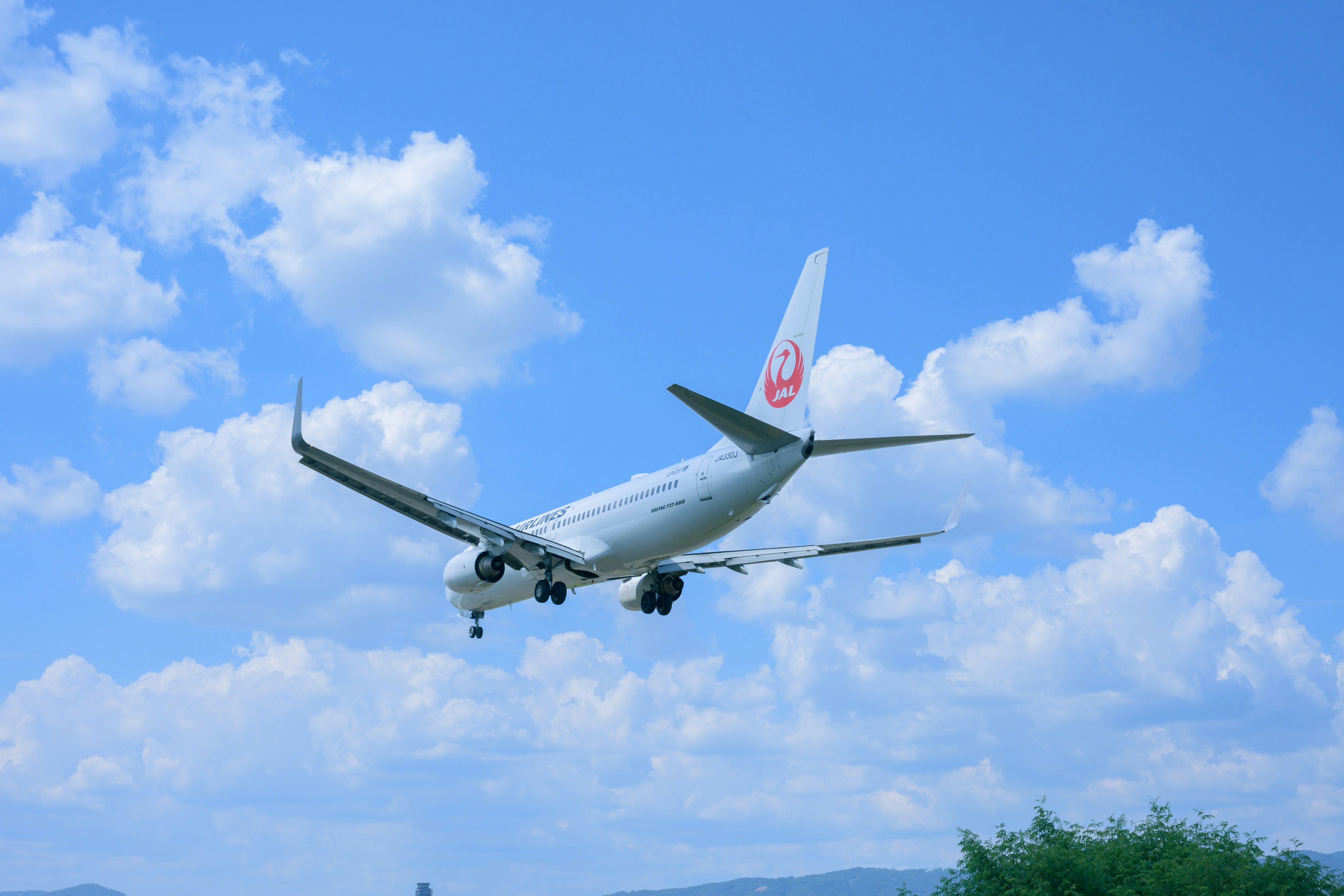 Landing airplane against a blue sky