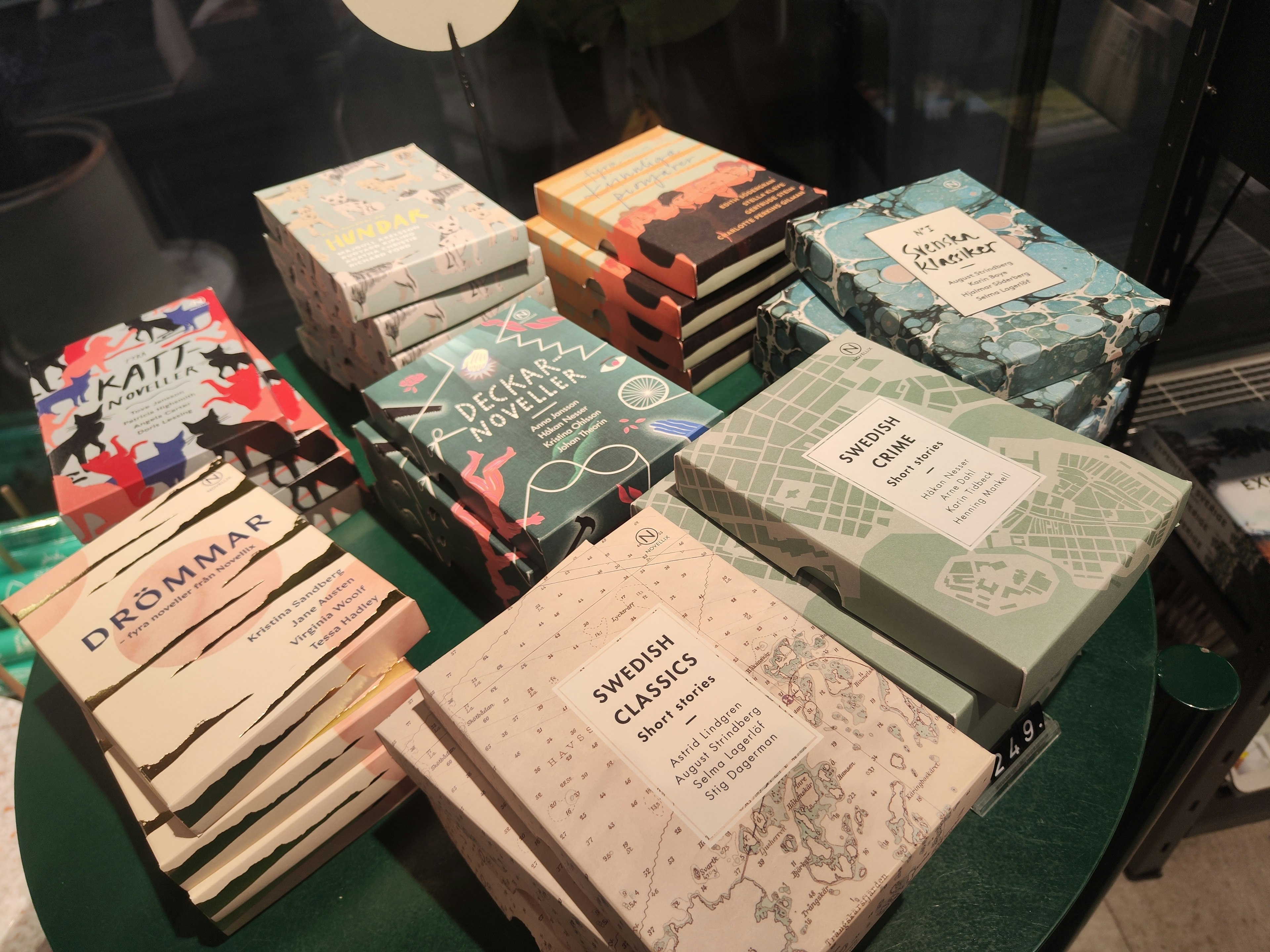 A collection of books with colorful covers stacked on a table