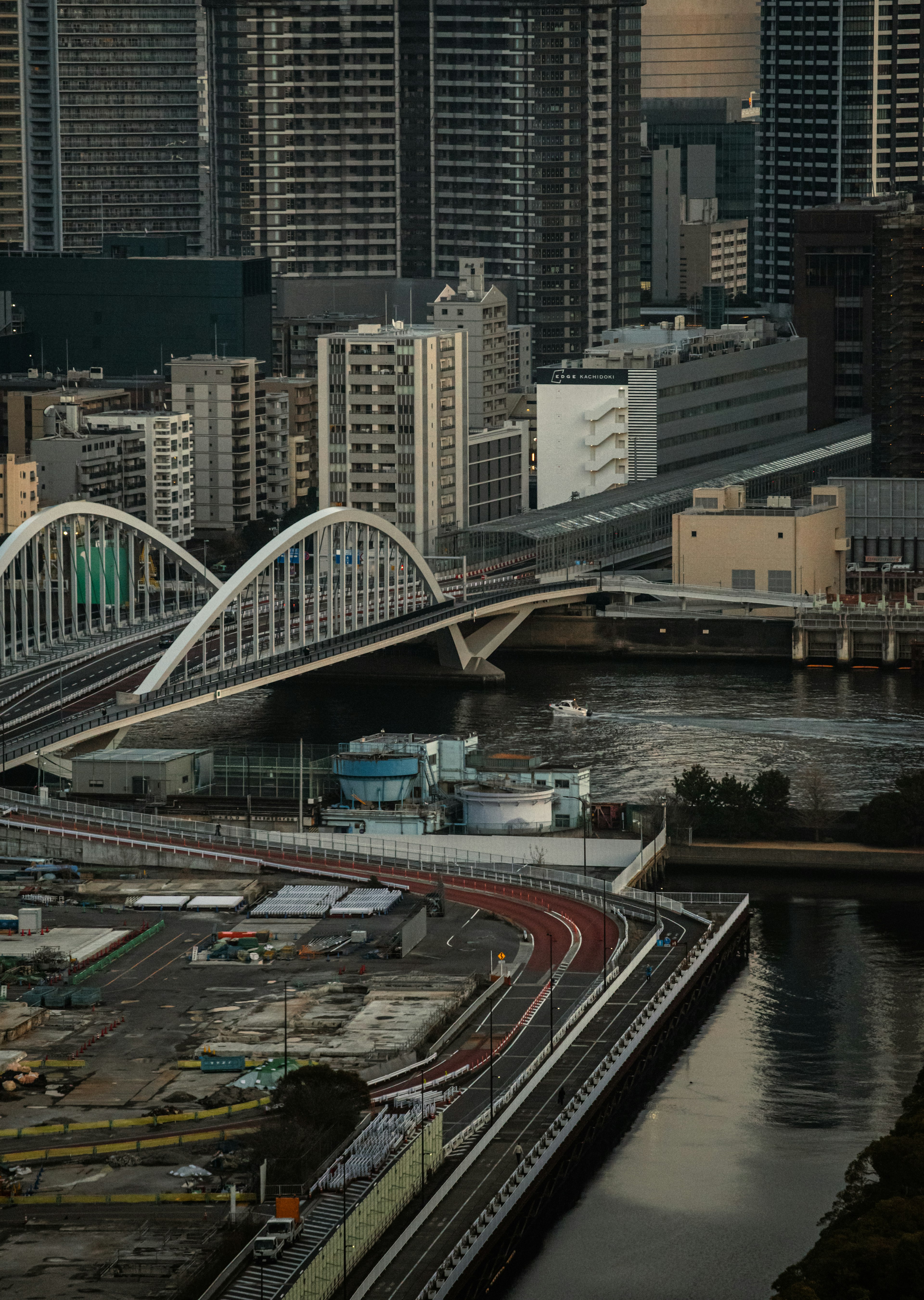 Urban landscape featuring skyscrapers and a modern arch bridge