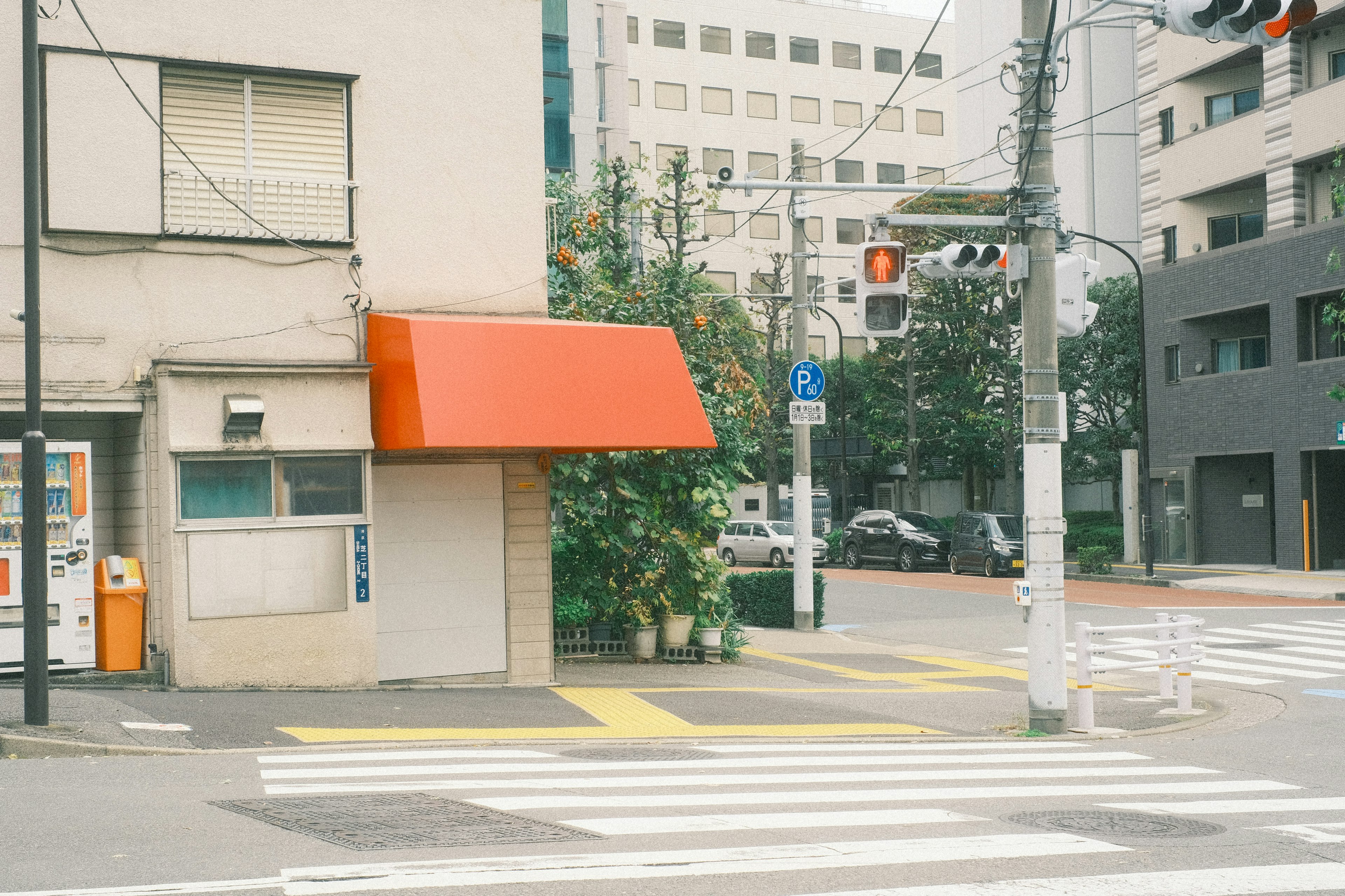 赤いテントのある建物と交差点の風景