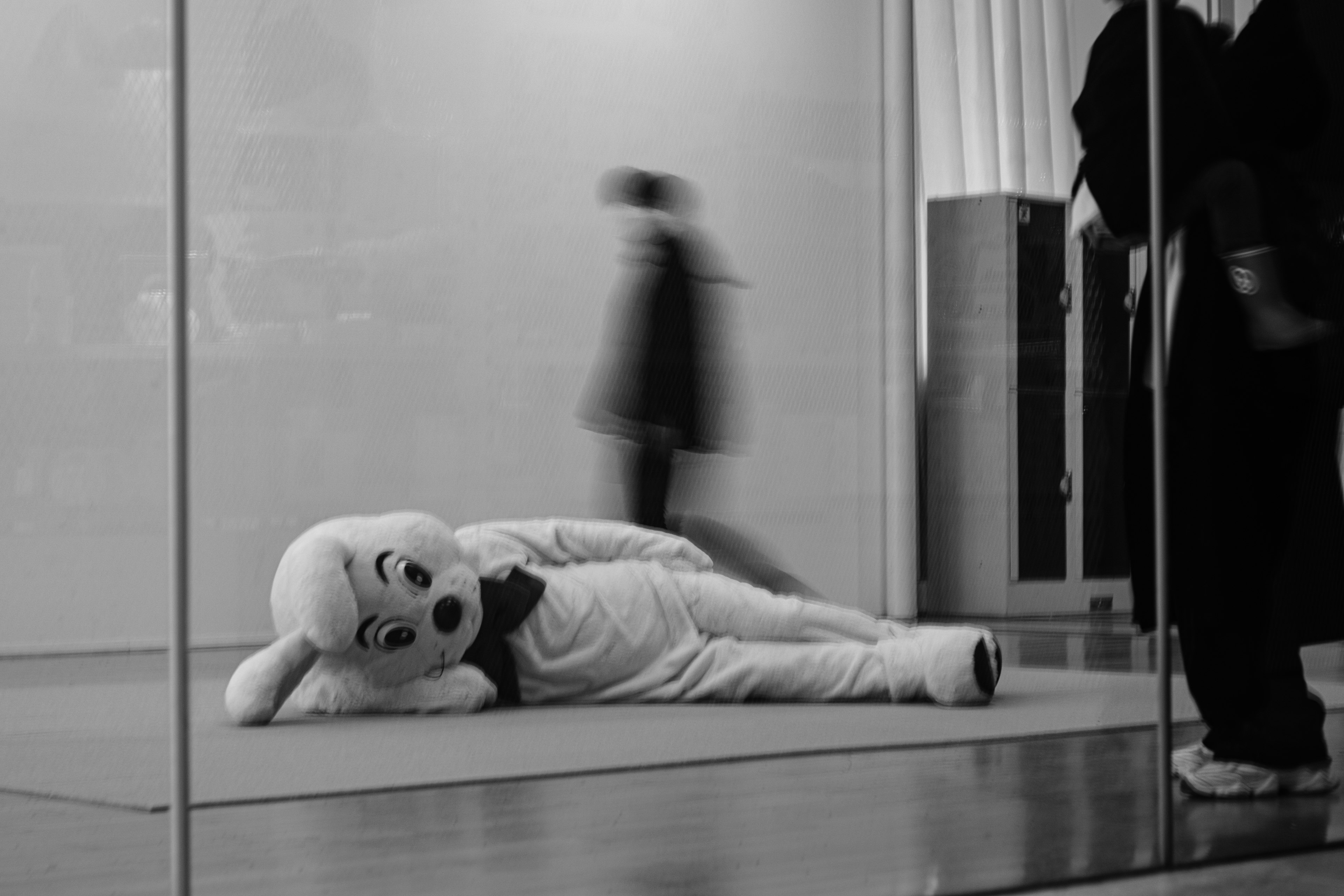 A character costume lying down in a black and white setting