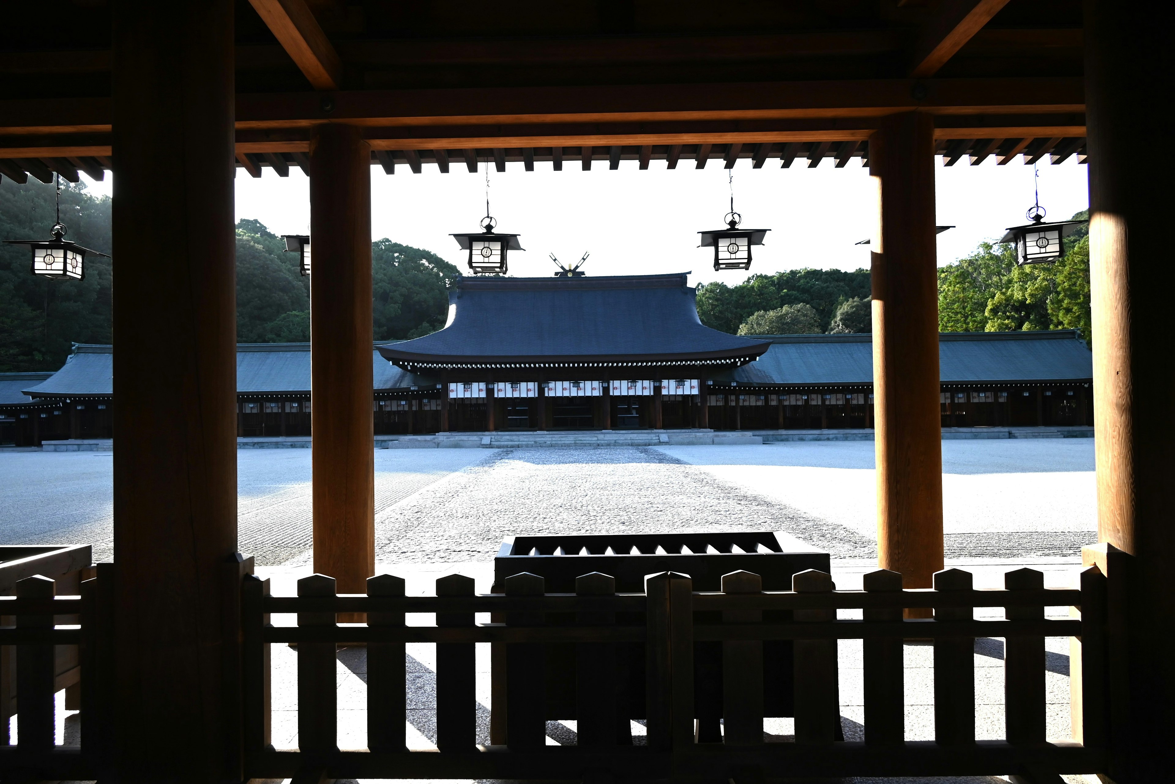 Beautiful interior view of a shrine with soft sunlight illuminating traditional architecture and gardens