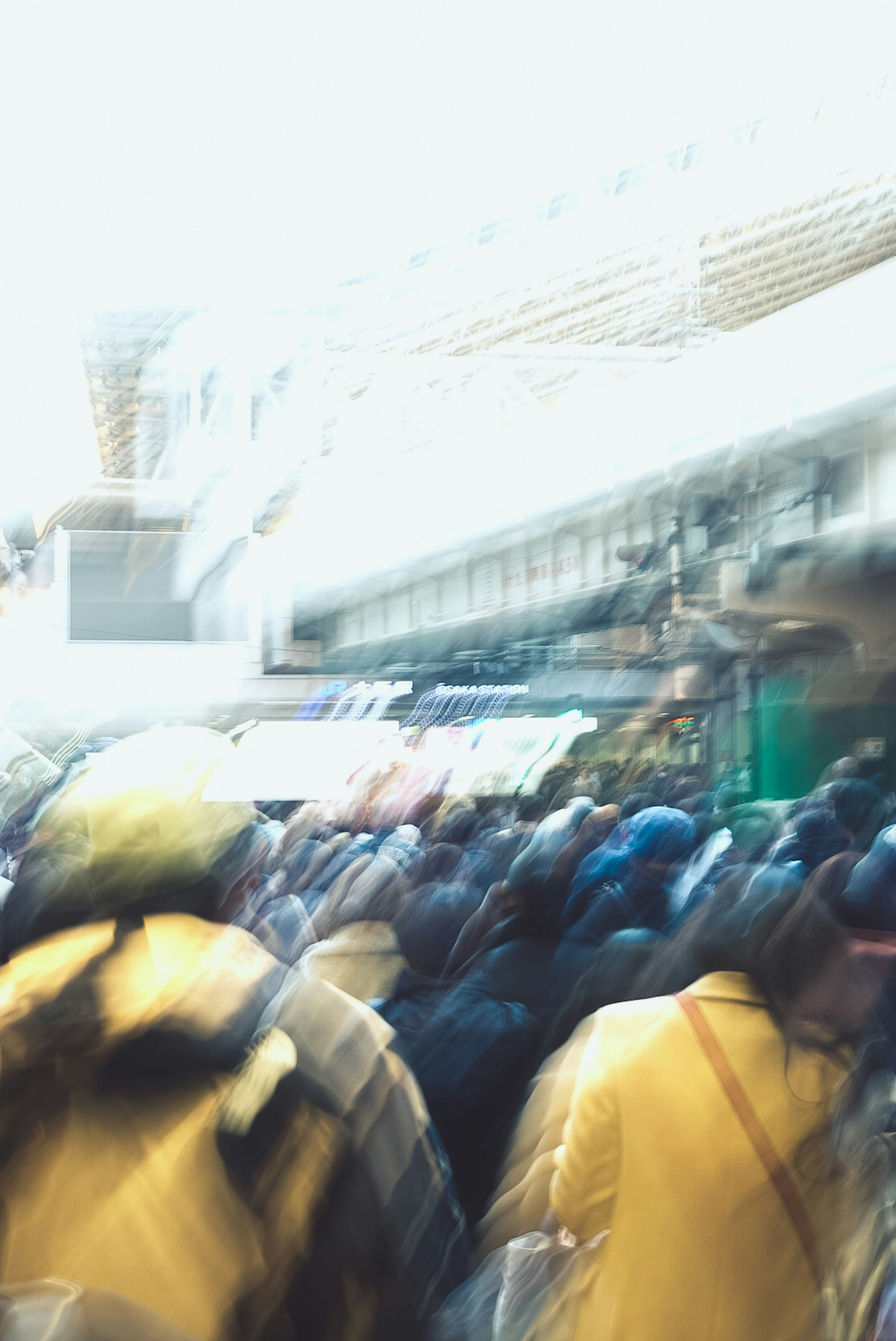 Blurred crowd of people with bright urban background