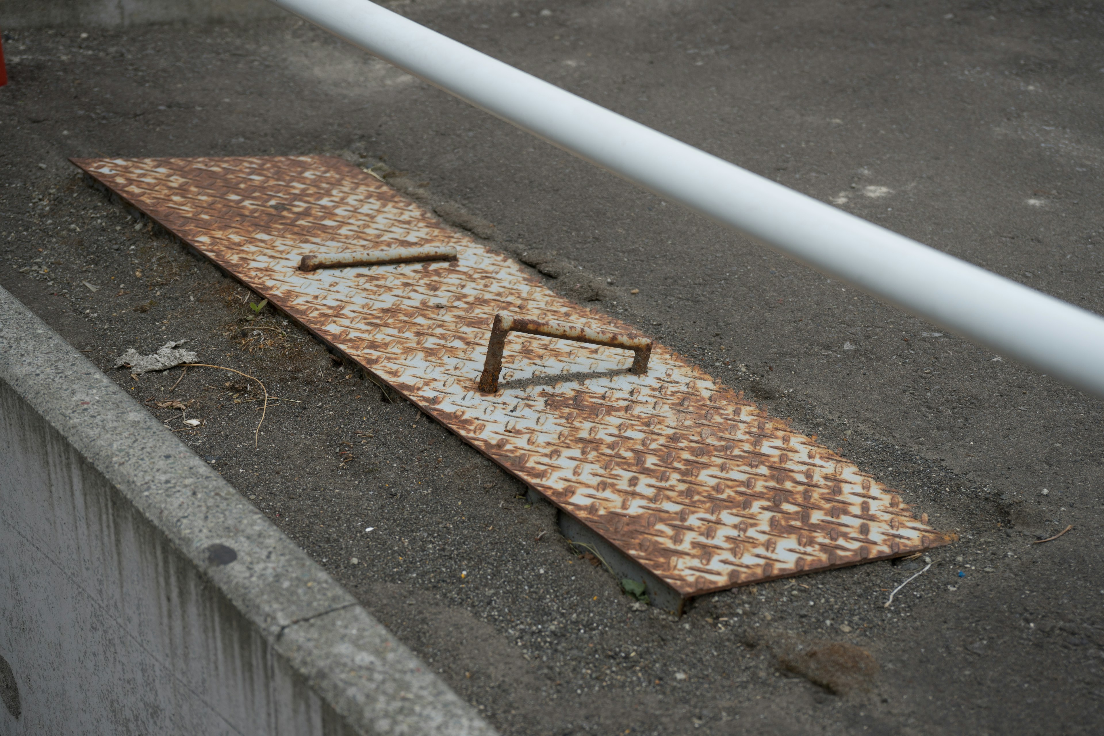 Rusty metal plate lying on the ground