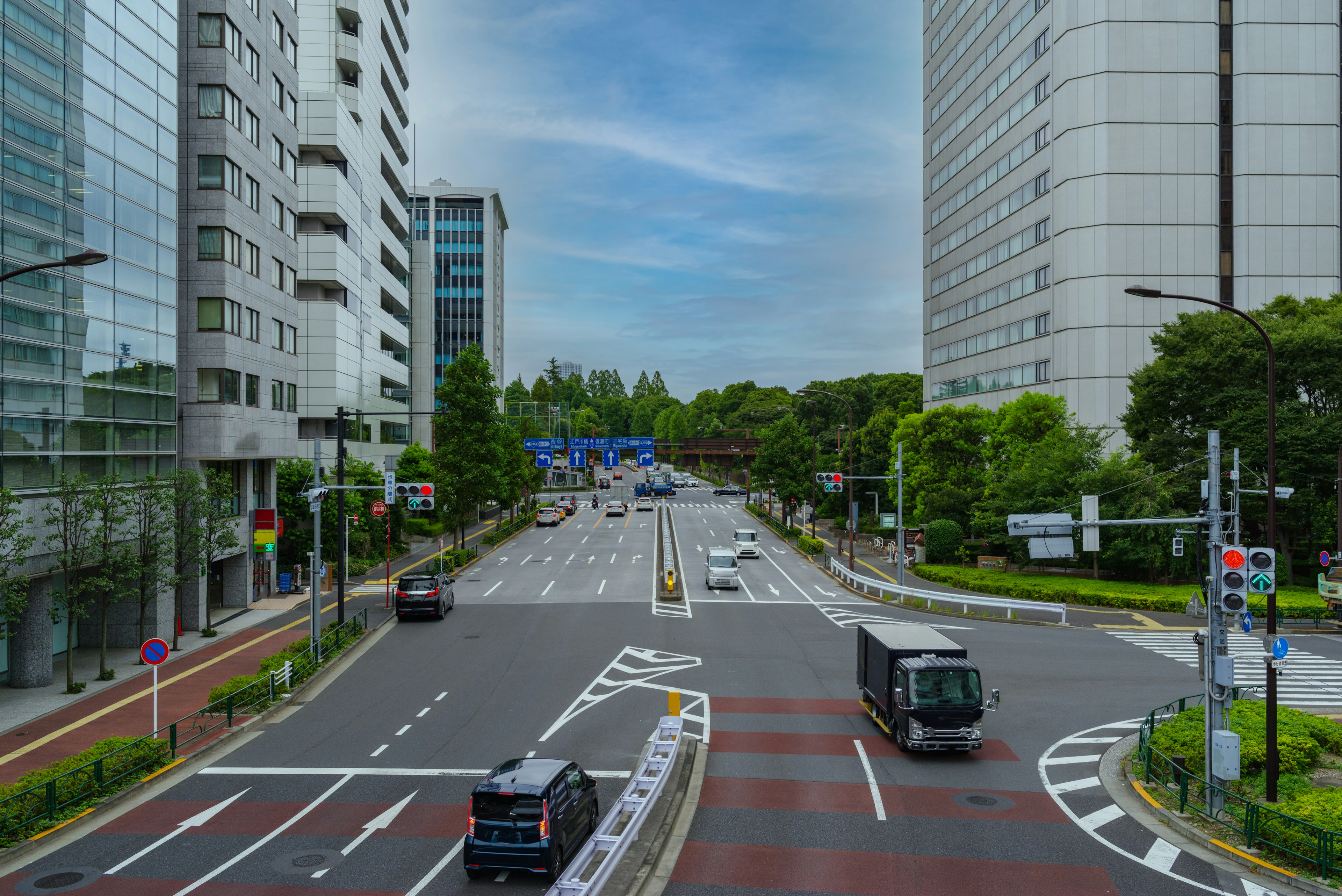 Urban intersection with skyscrapers and greenery