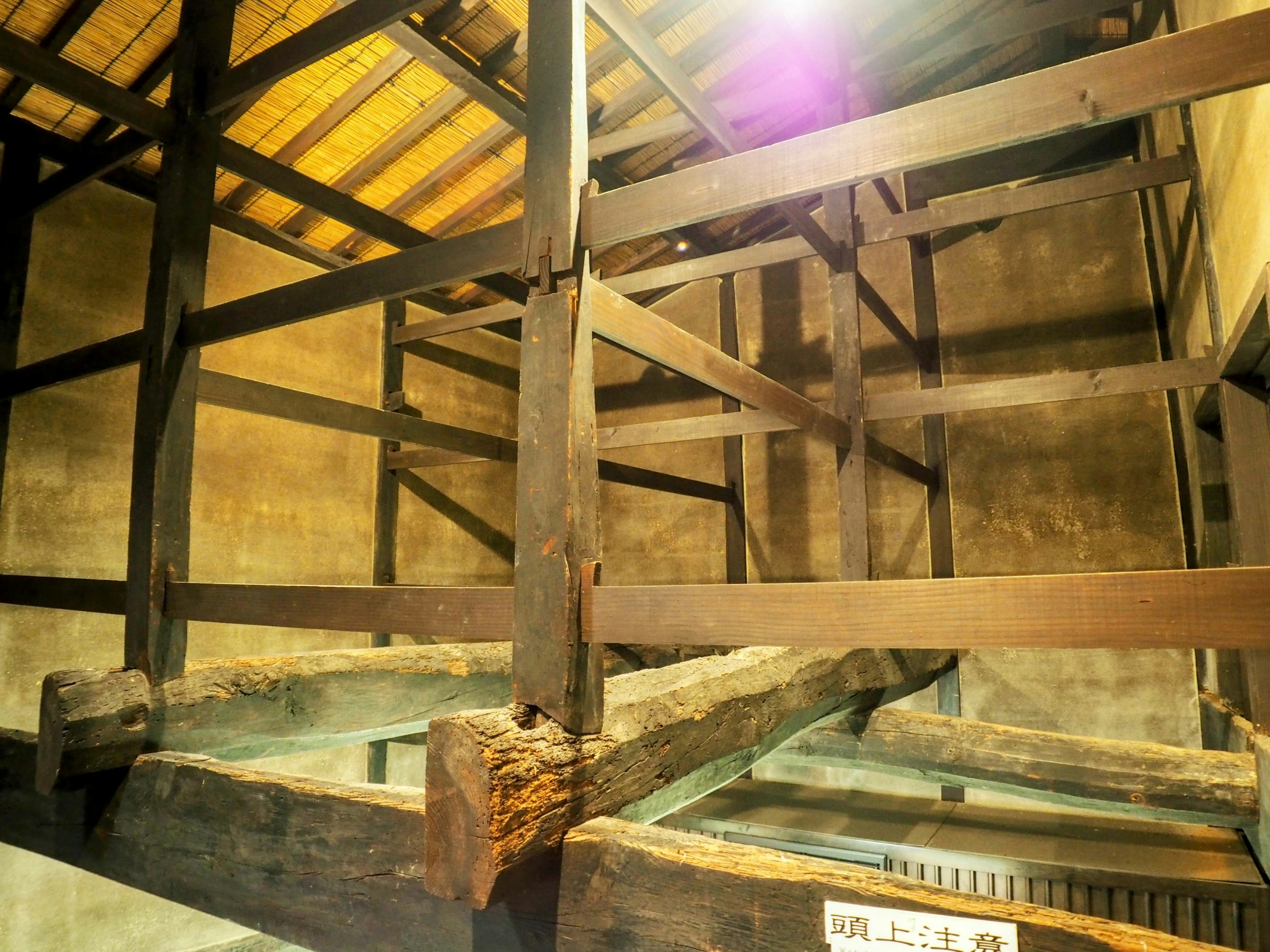 Interior structure of an old wooden building with beams and rustic elements