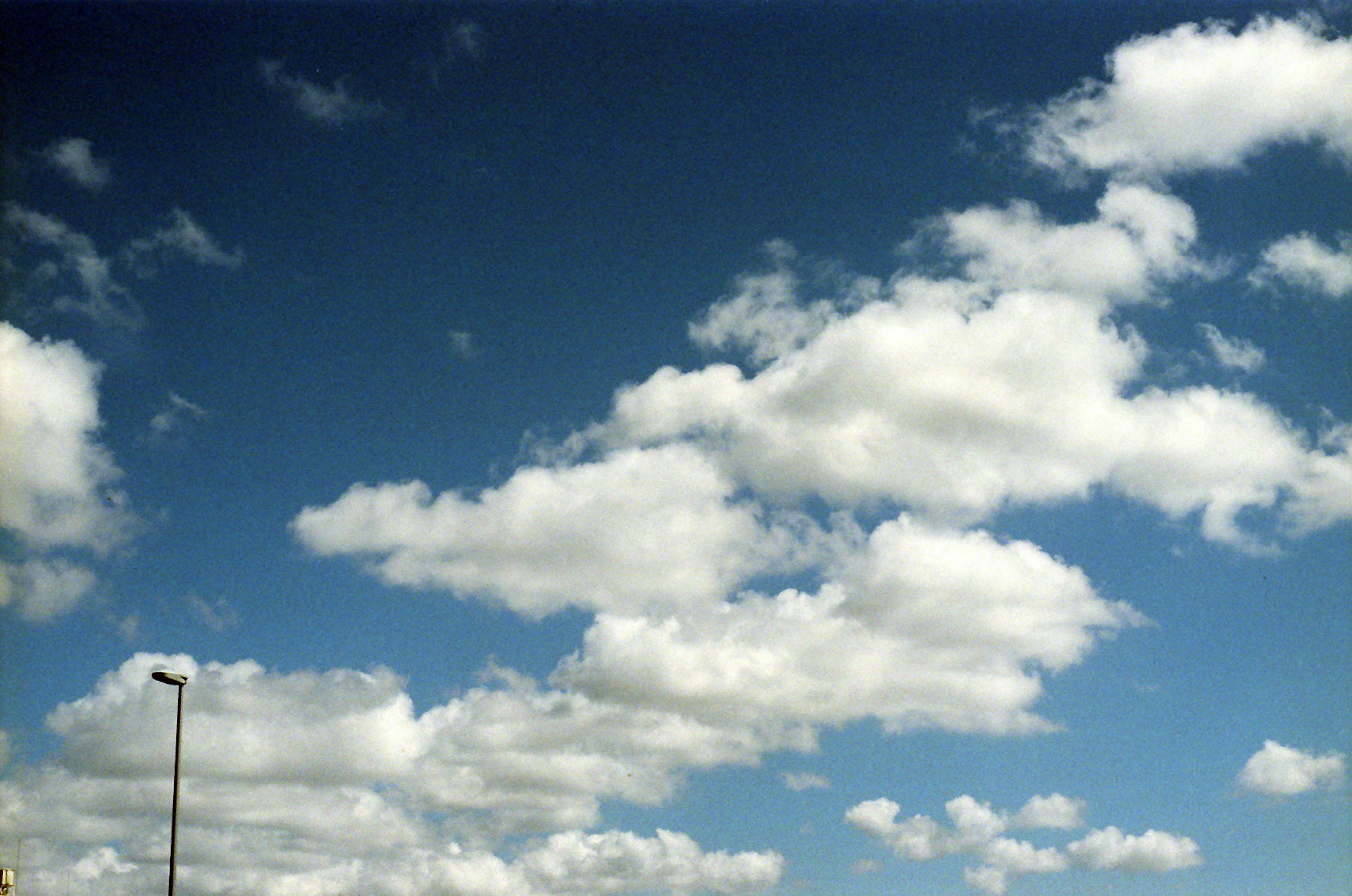 A landscape of white clouds floating in a blue sky