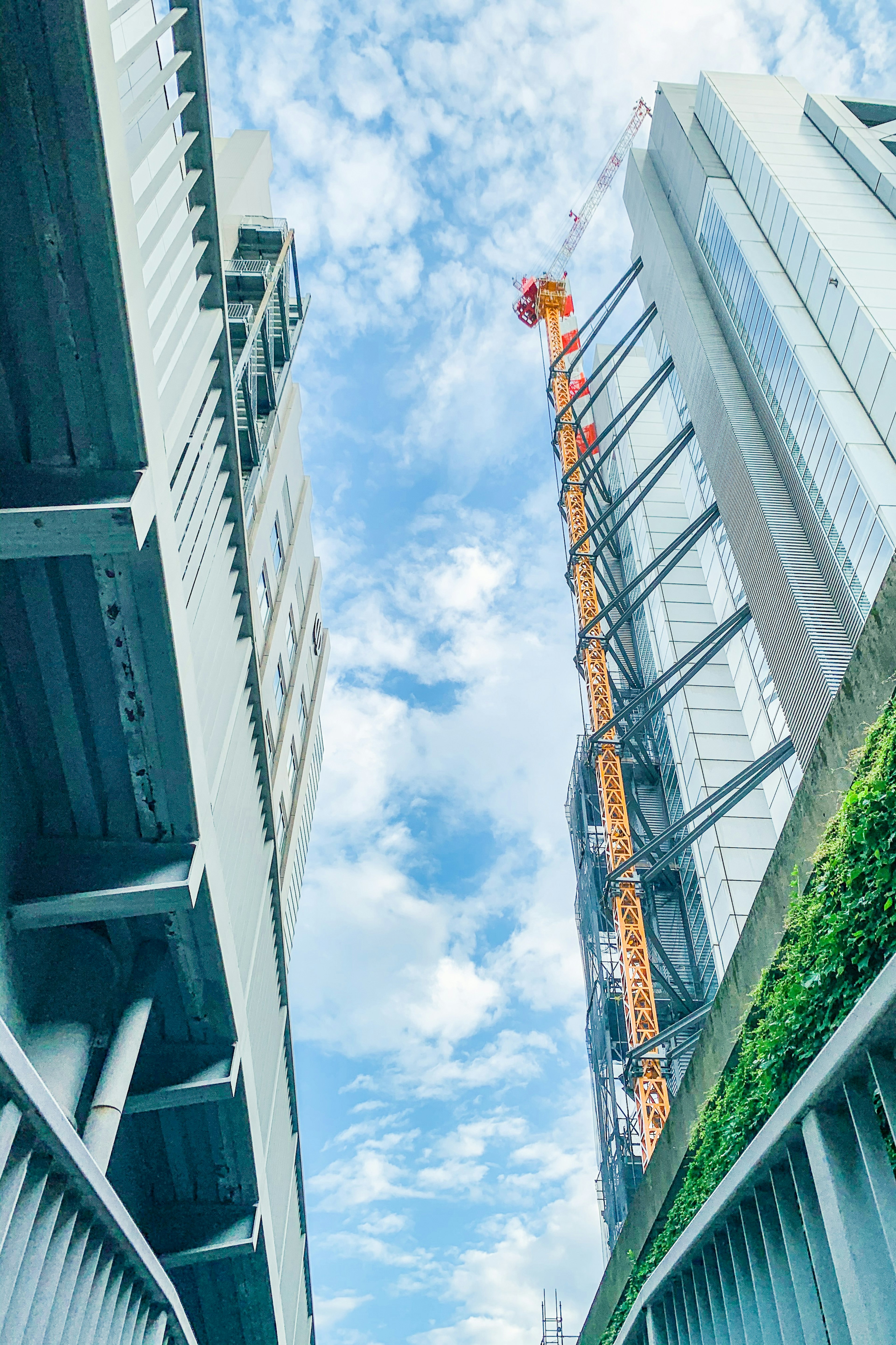 Perspective view of towering buildings under a blue sky