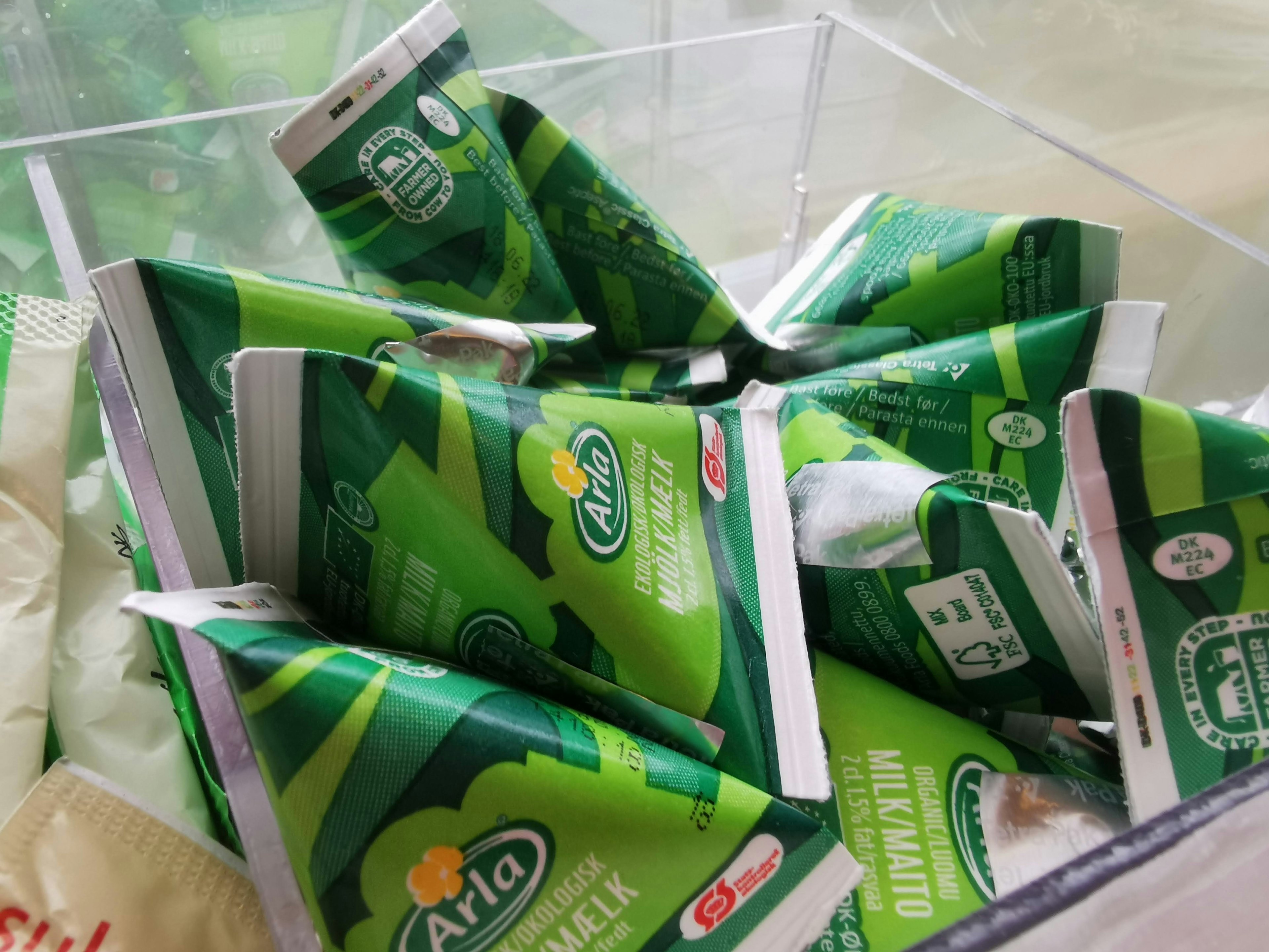 Green packages of Arla products packed in a container