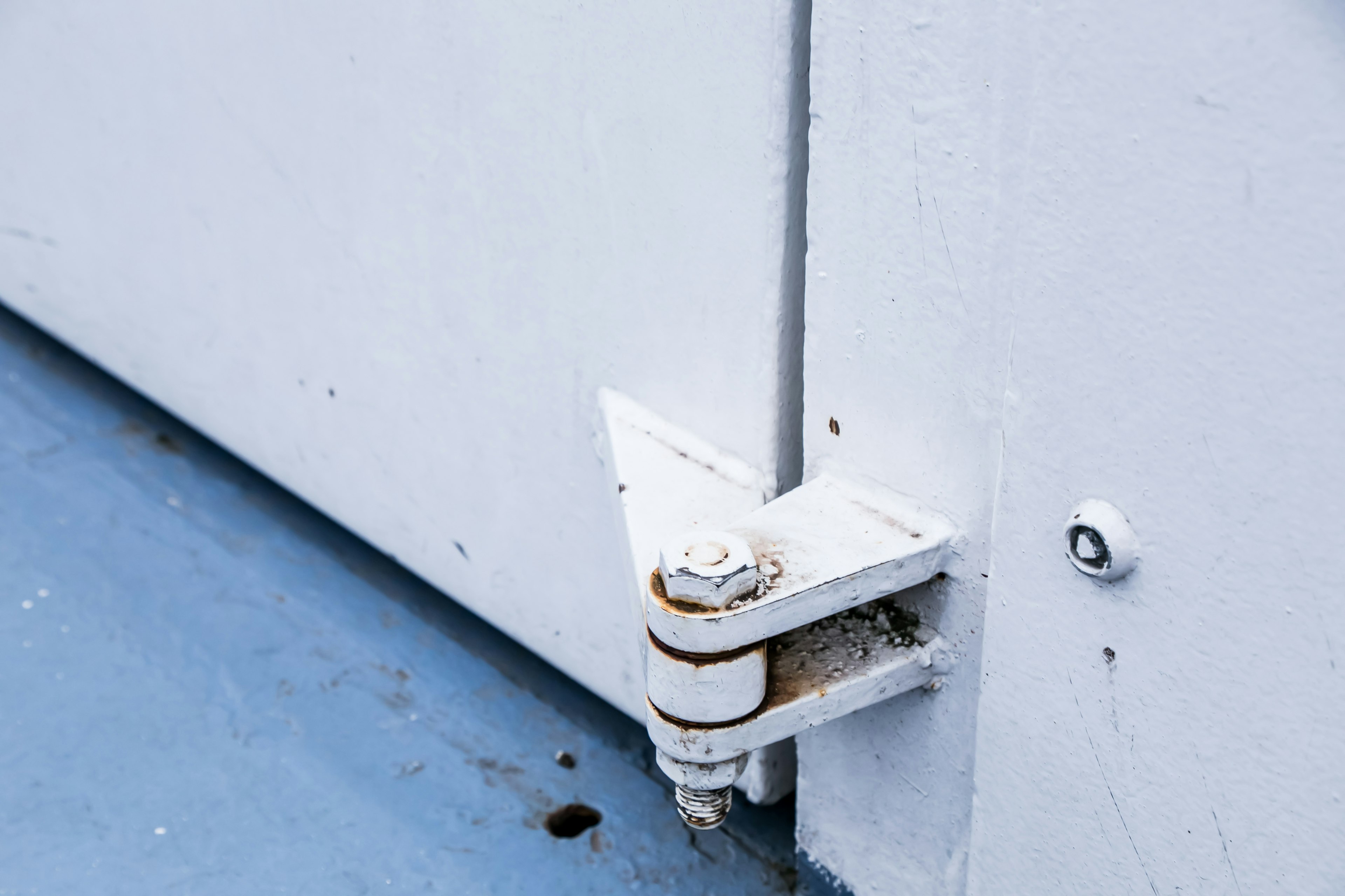 Close-up of a white door hinge