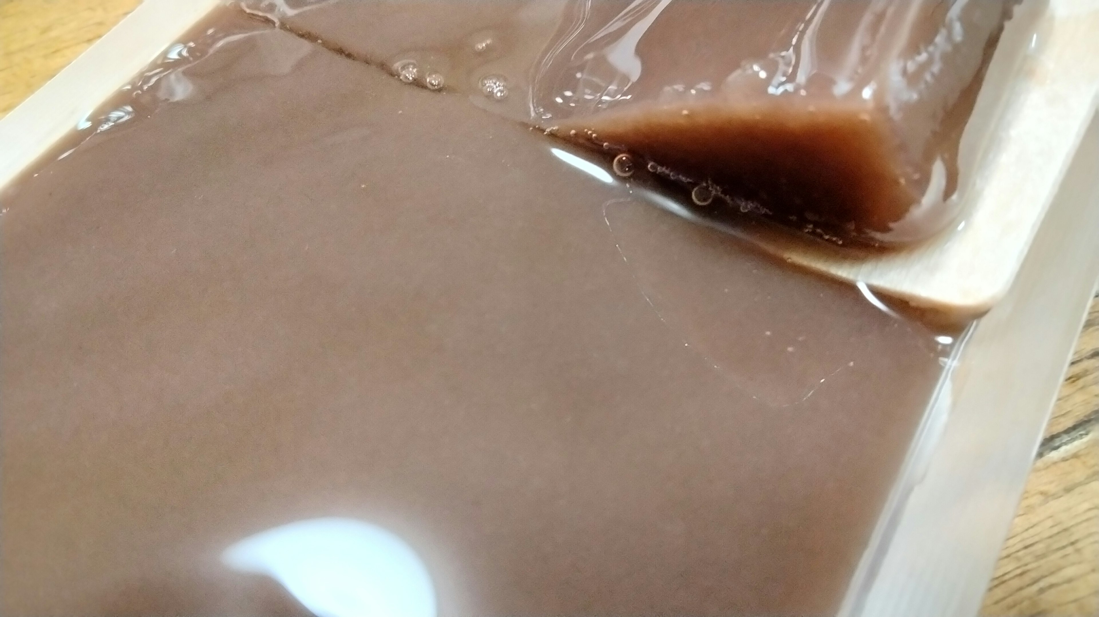 Glossy brown jelly-like dessert in a package