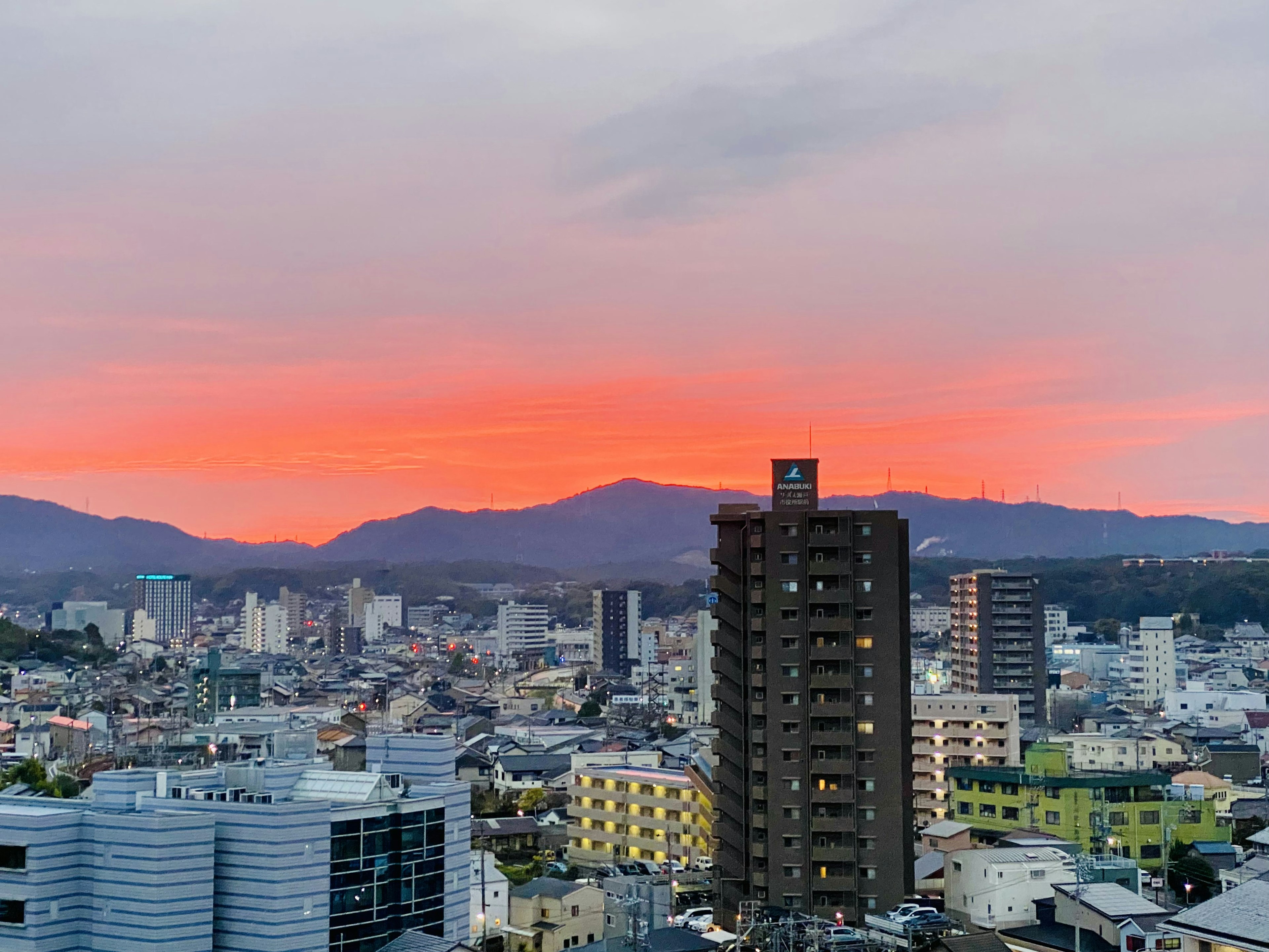 Paysage urbain au coucher du soleil avec des immeubles et des montagnes en arrière-plan