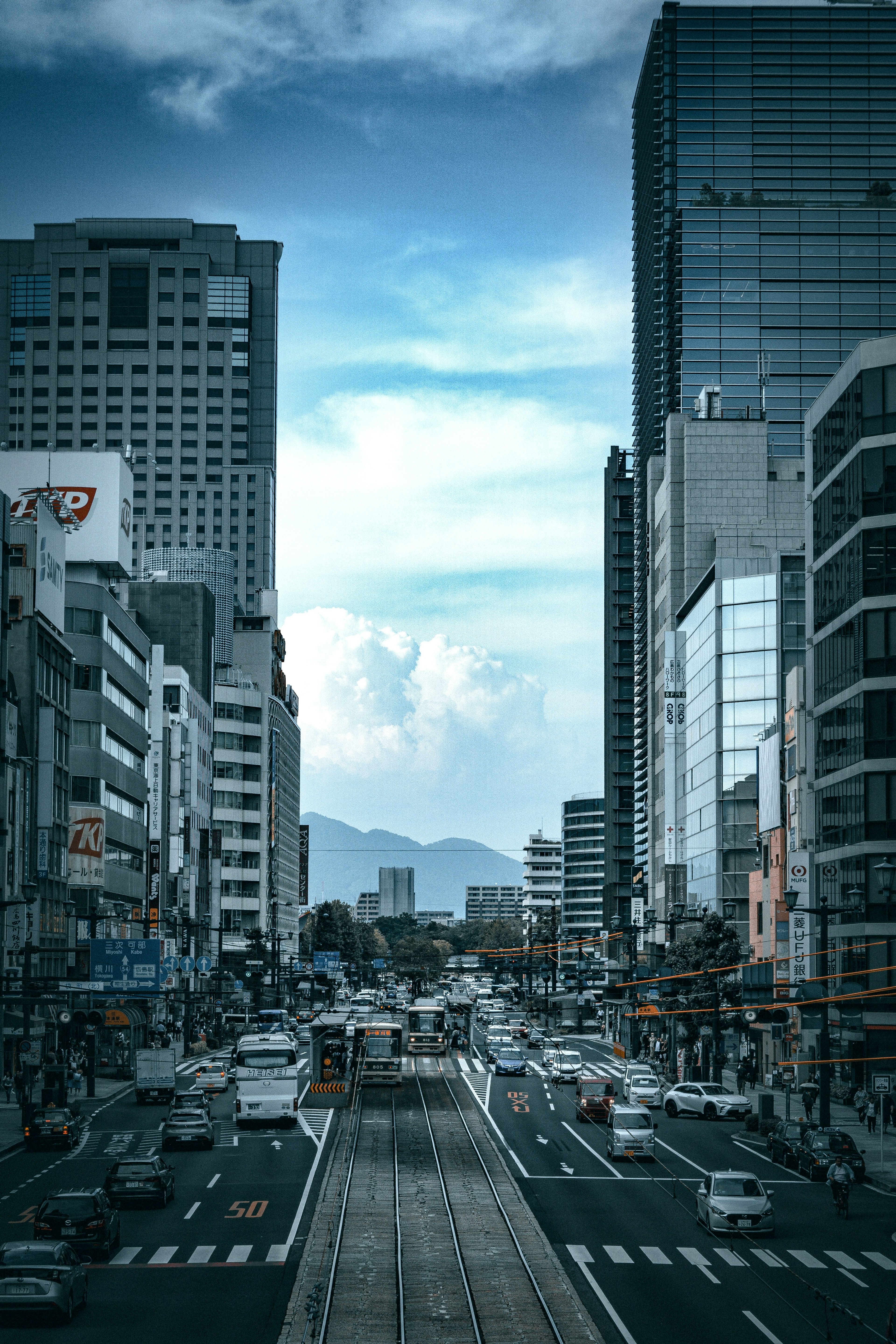 Urban street scene featuring high-rise buildings and vehicle traffic