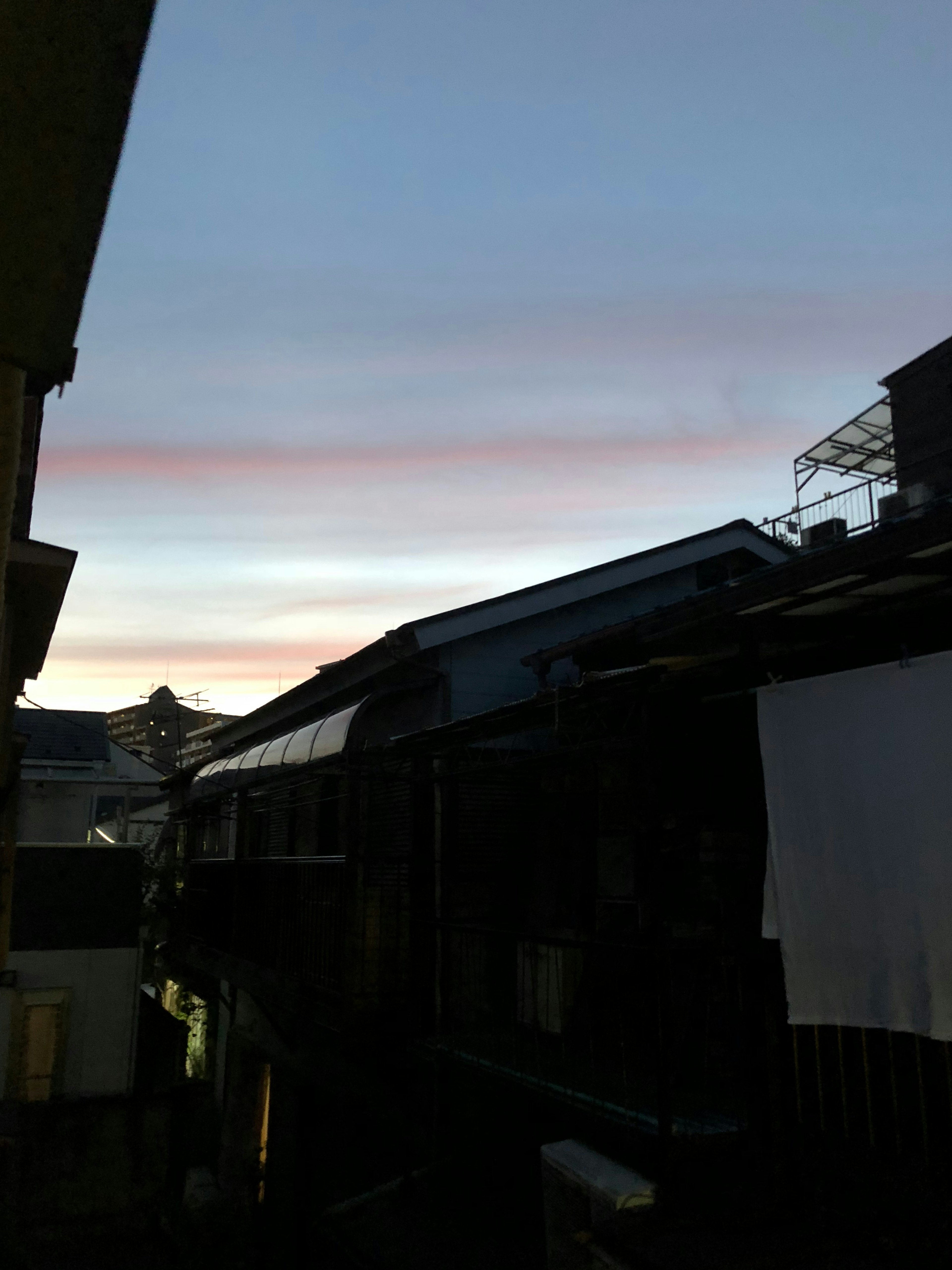 Urban scene at dusk with sunset sky and traditional buildings