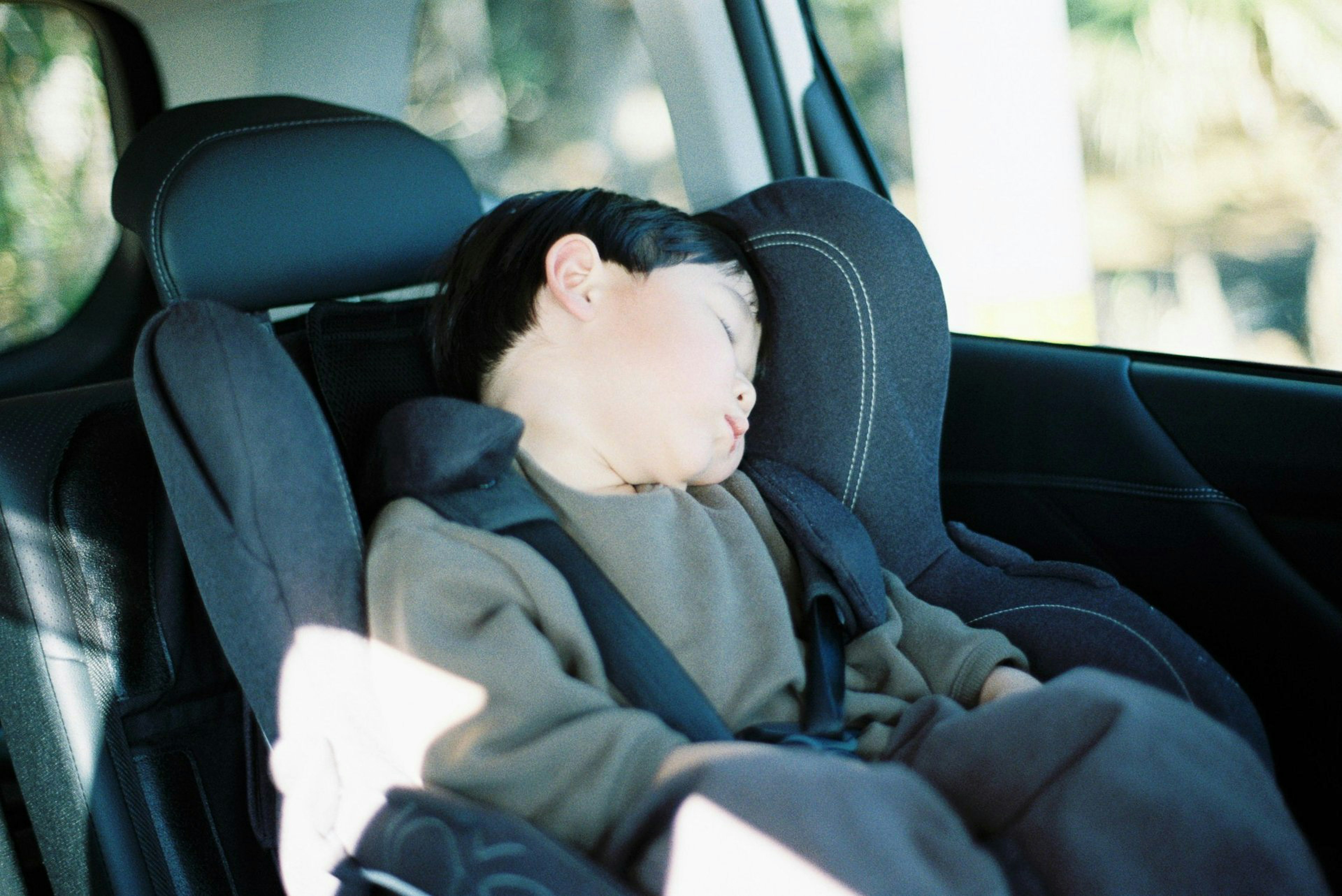 A child sleeping in a car seat