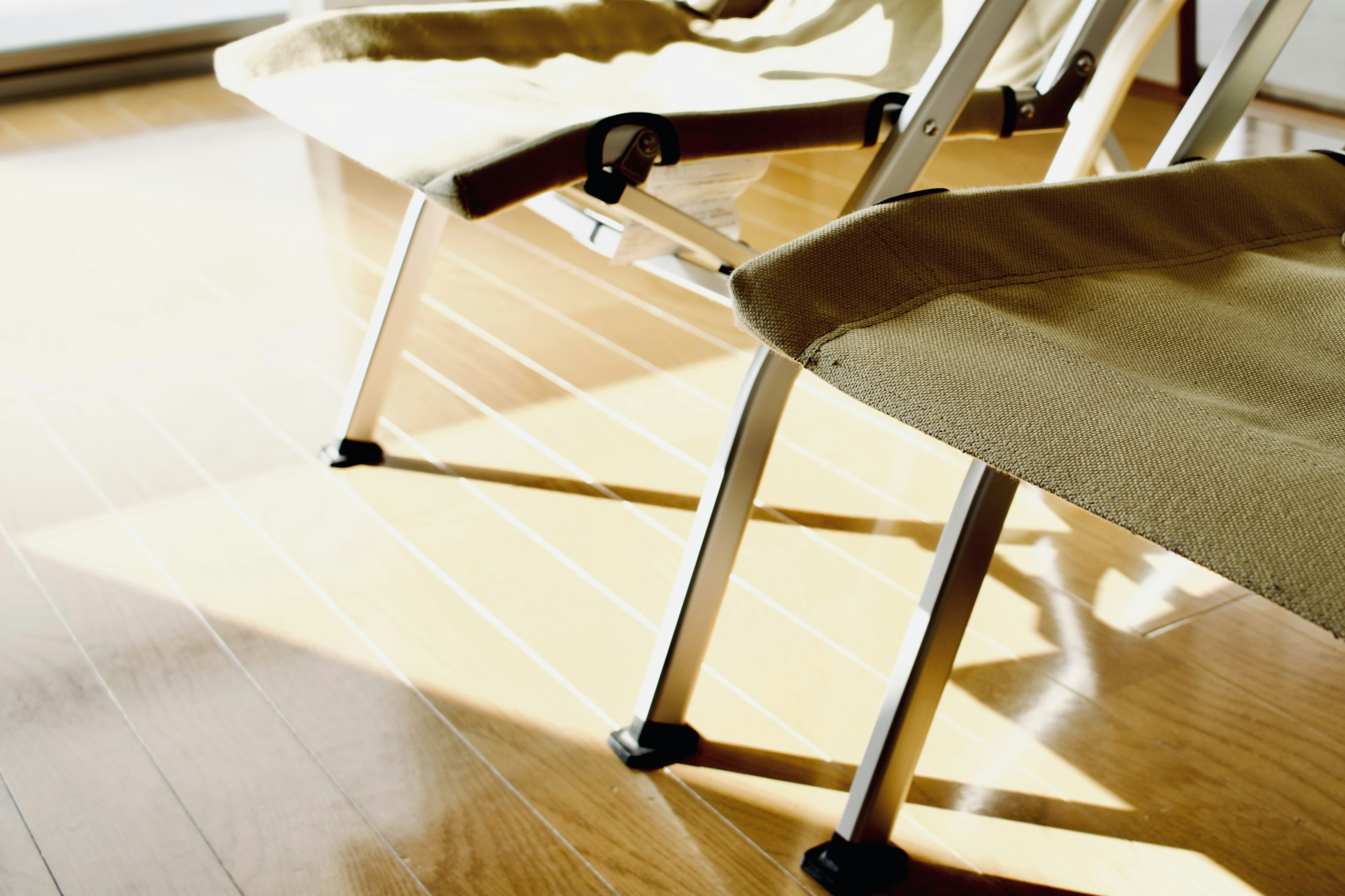 Two chairs in a bright room with wooden flooring