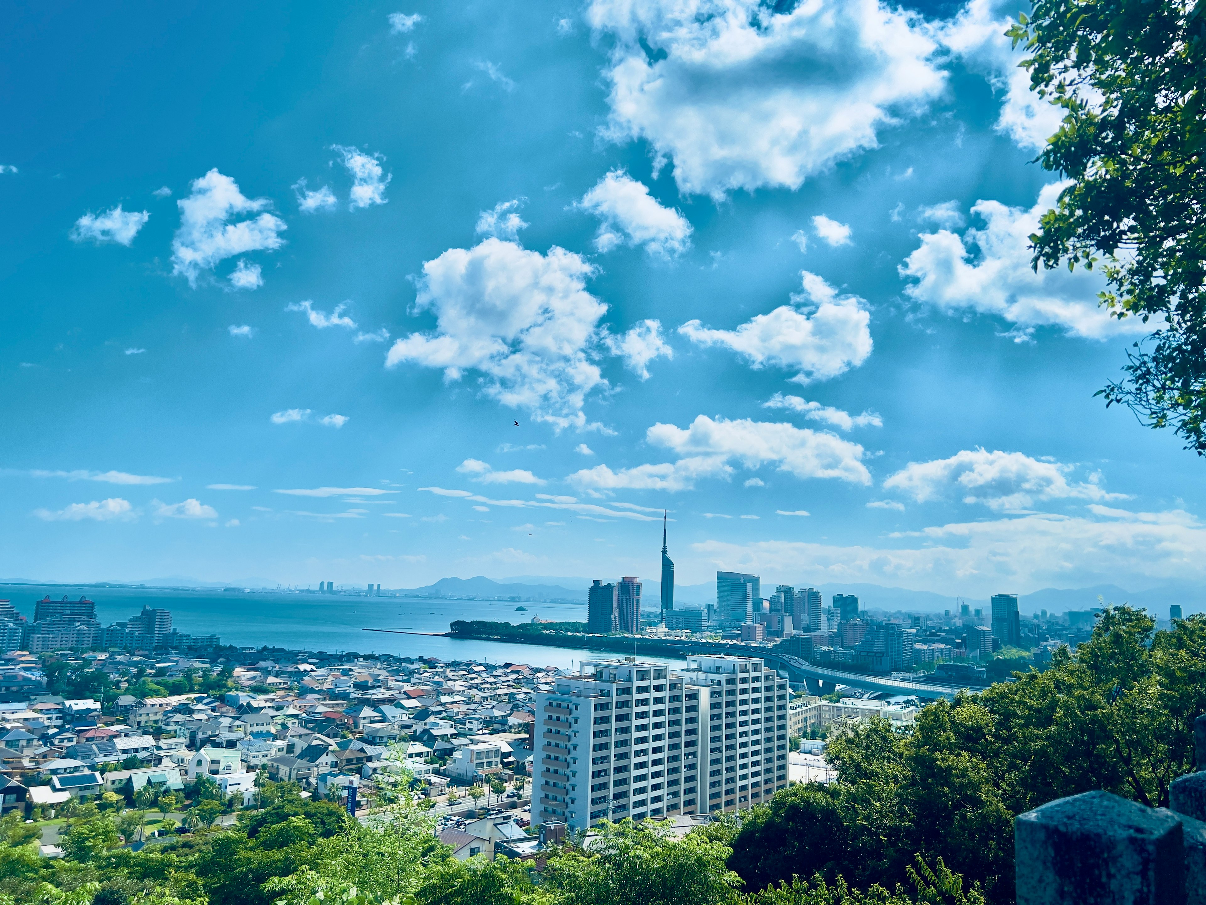 Paysage urbain avec ciel bleu et nuages comprenant la mer et des gratte-ciel