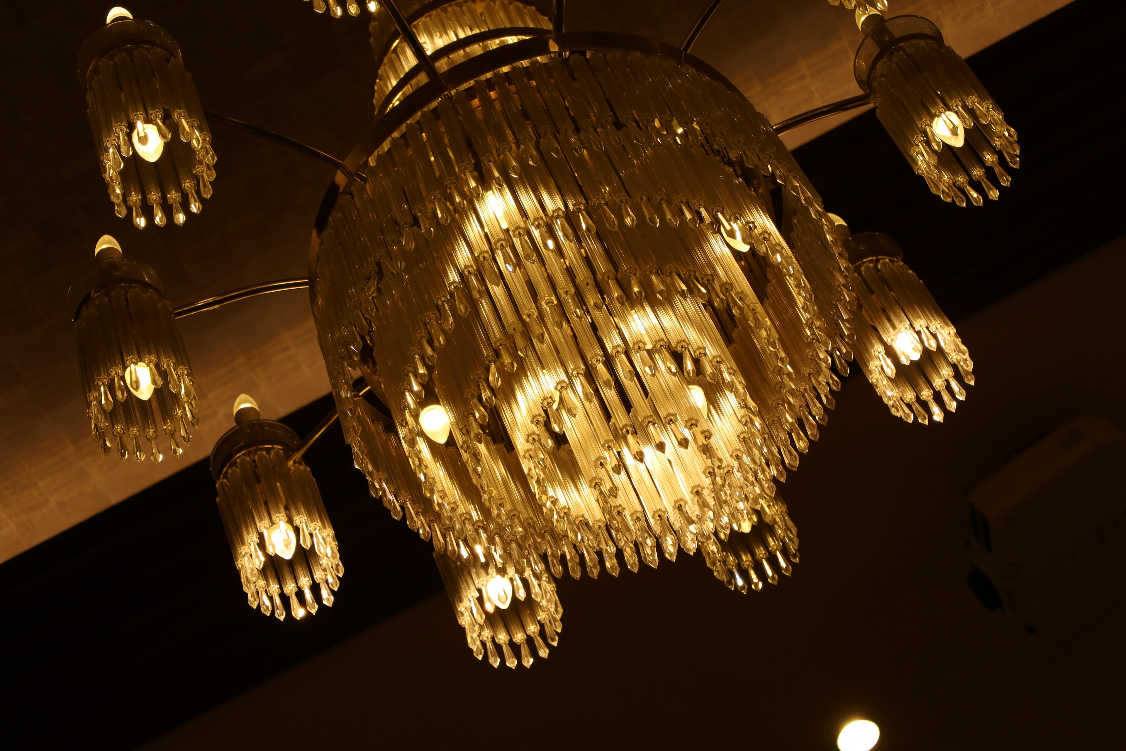 Detailed view of a luxurious chandelier with warm lighting