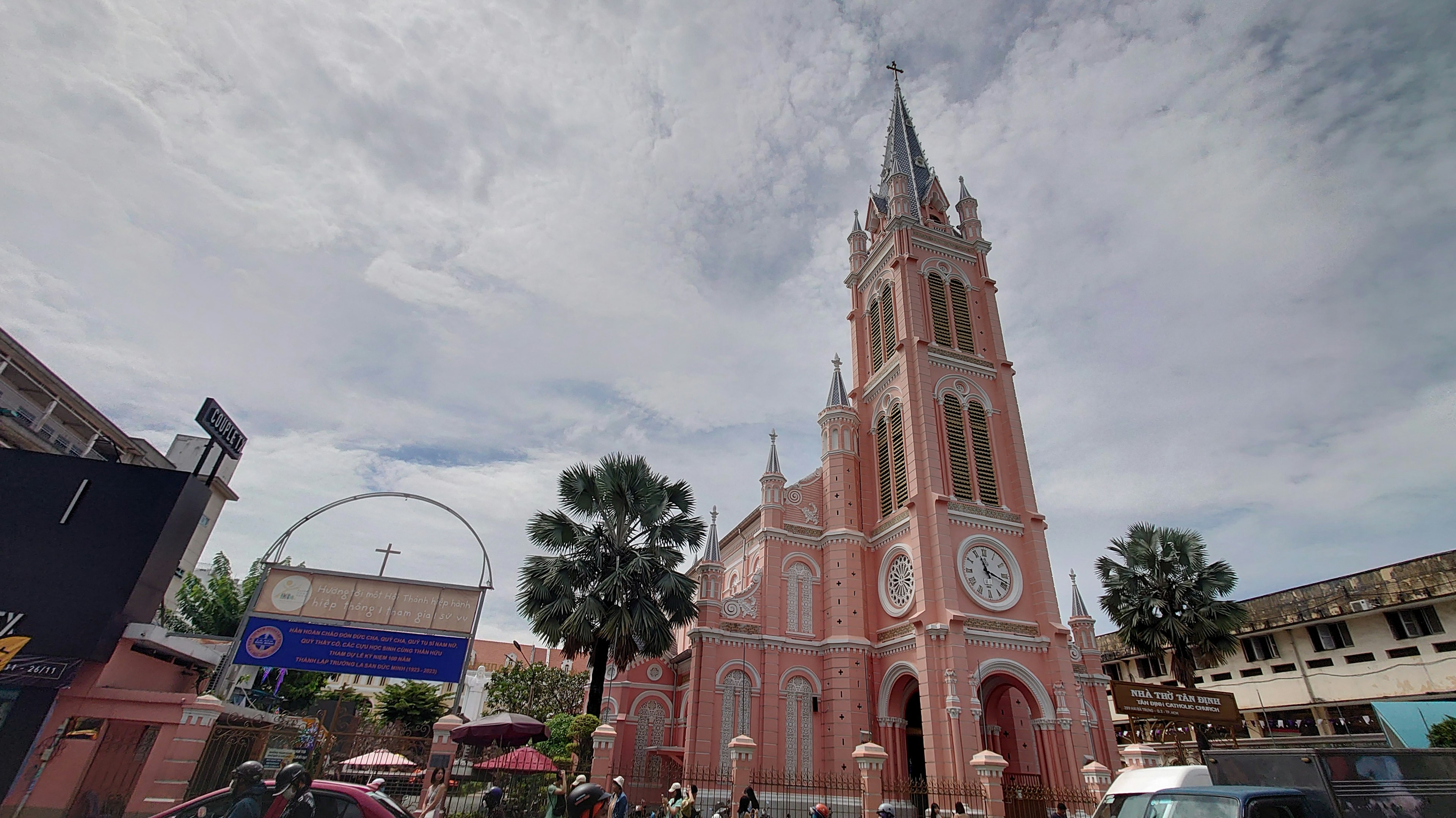 Prominent pink church tower in a vibrant urban setting