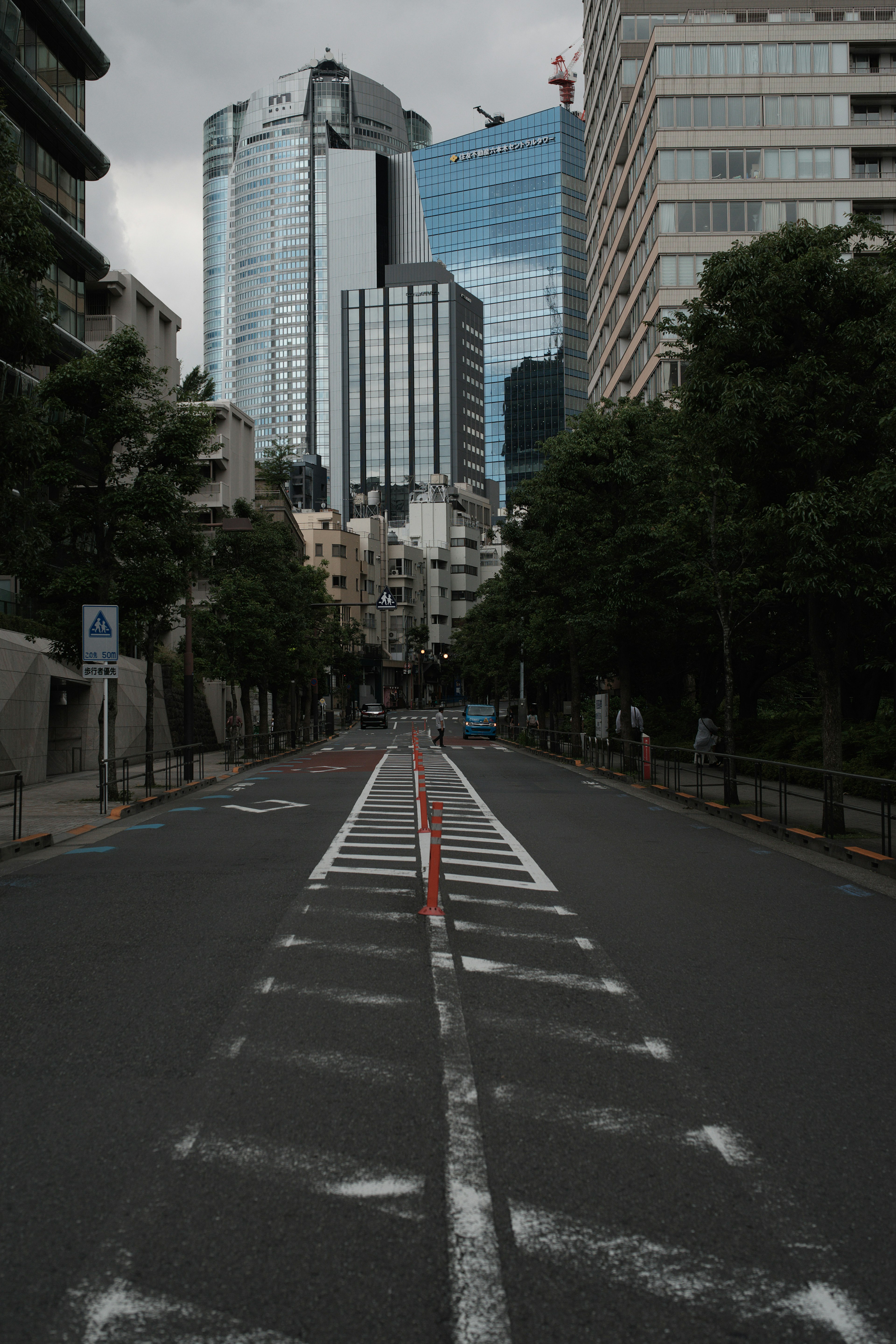 Quiet street reflecting skyscrapers and sky in urban Tokyo