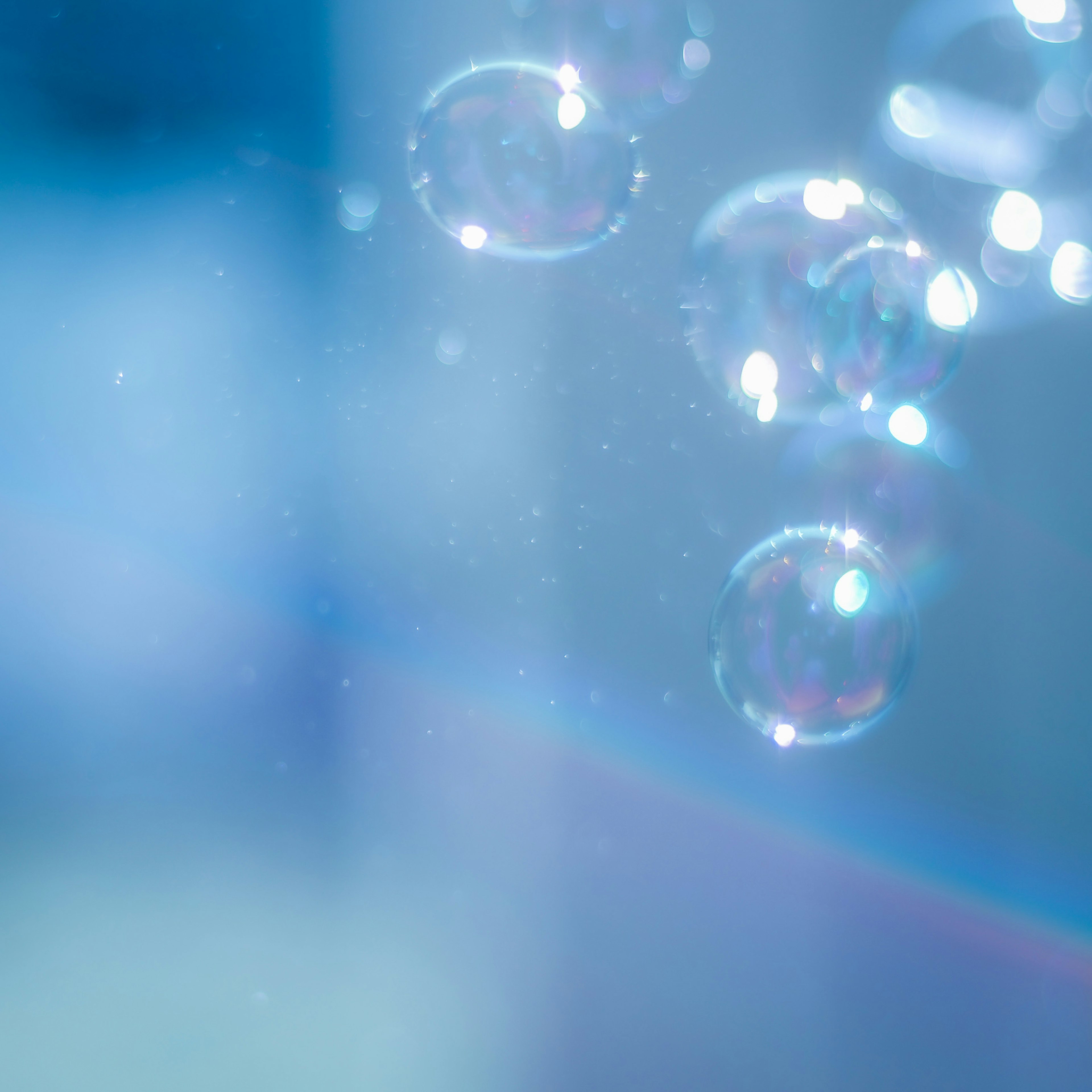 Close-up of bubbles floating against a blue background