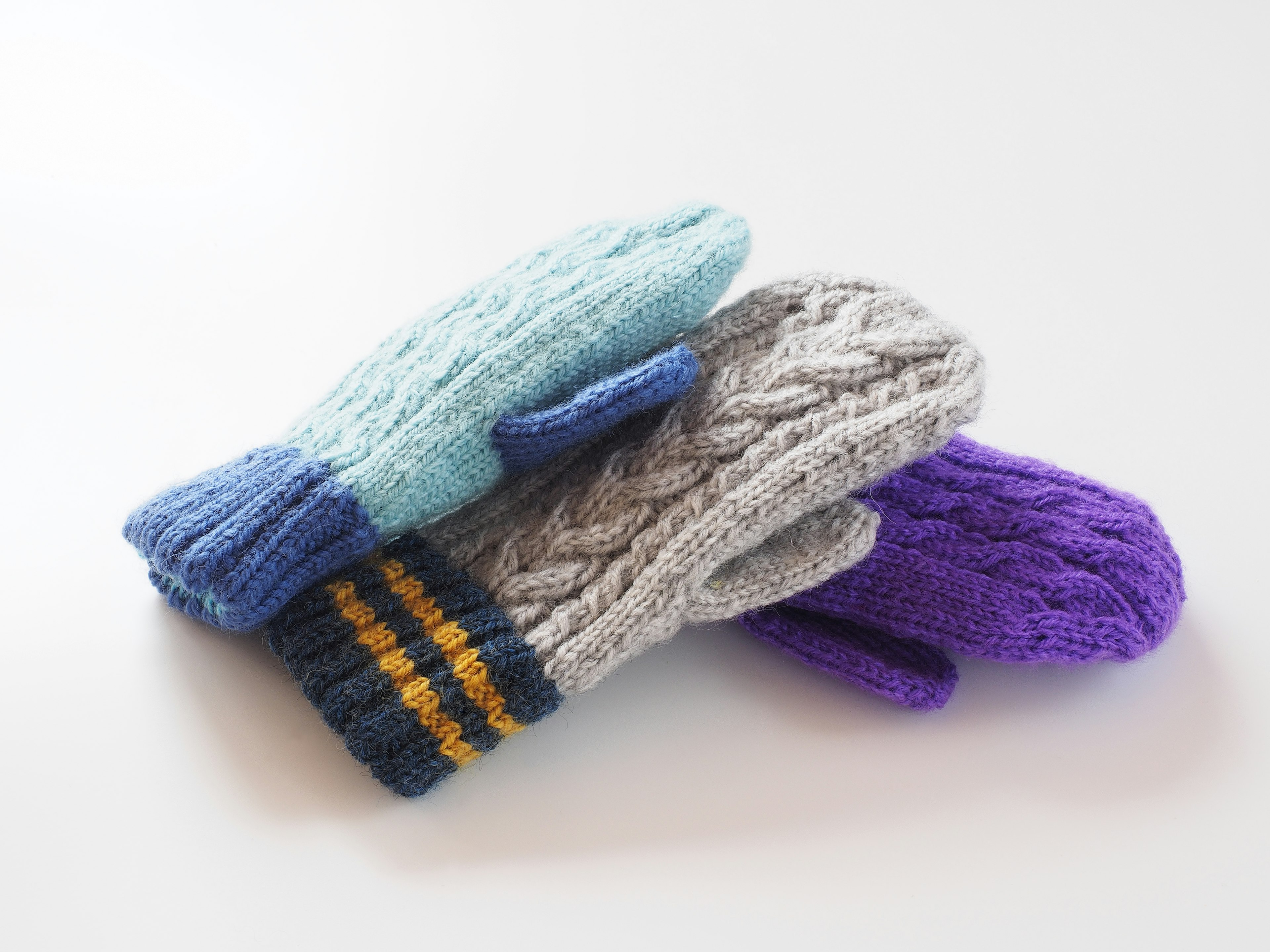 Colorful mittens stacked together