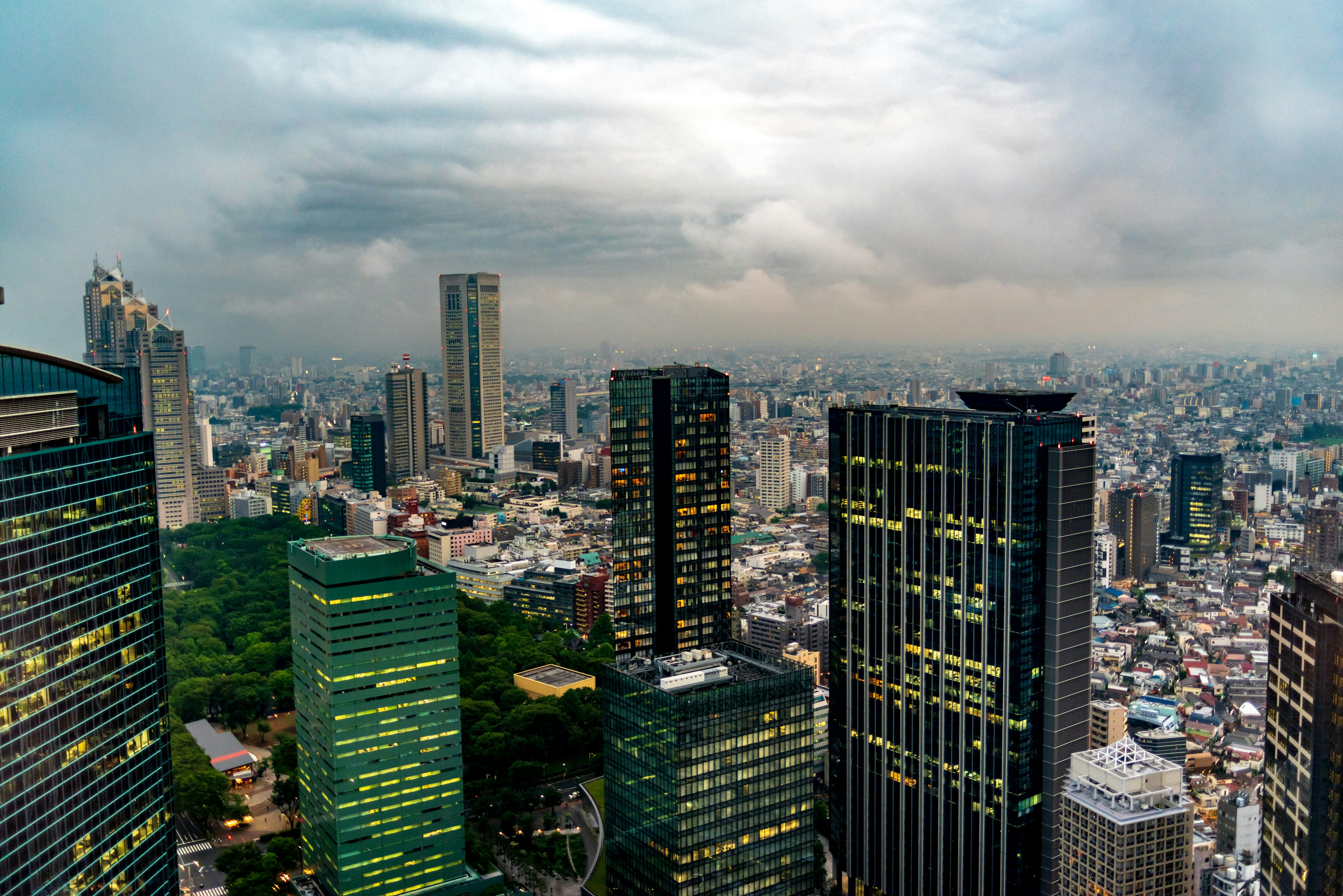 Aerial view of Tokyo's skyscrapers under a cloudy sky